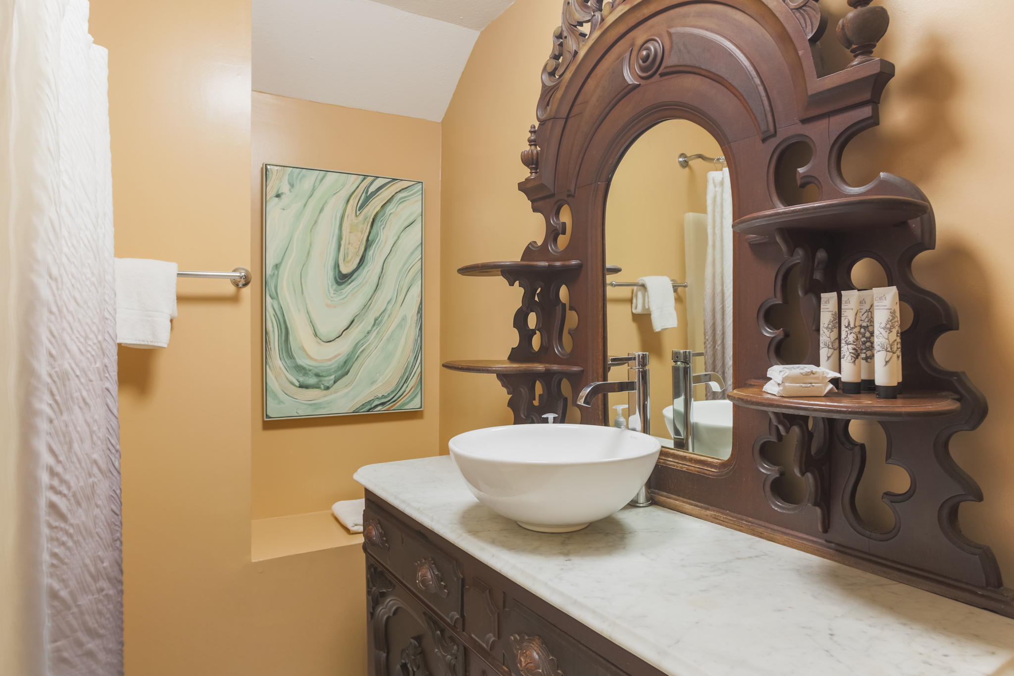 A beautiful wood vanity adds warmth and character to the bathroom’s design.