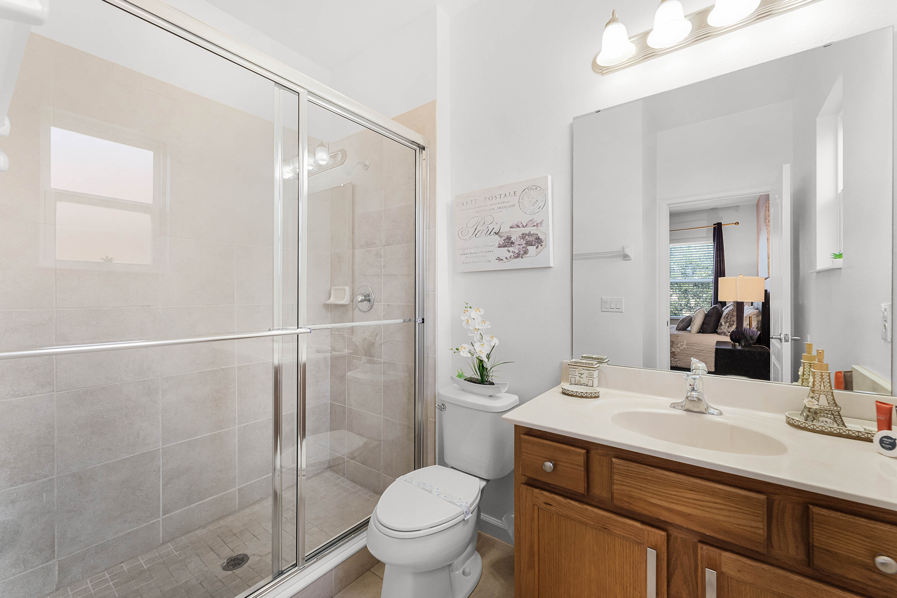 Paris bedroom’s upstairs ensuite bathroom, with a walk-in shower, toilet and vanity.