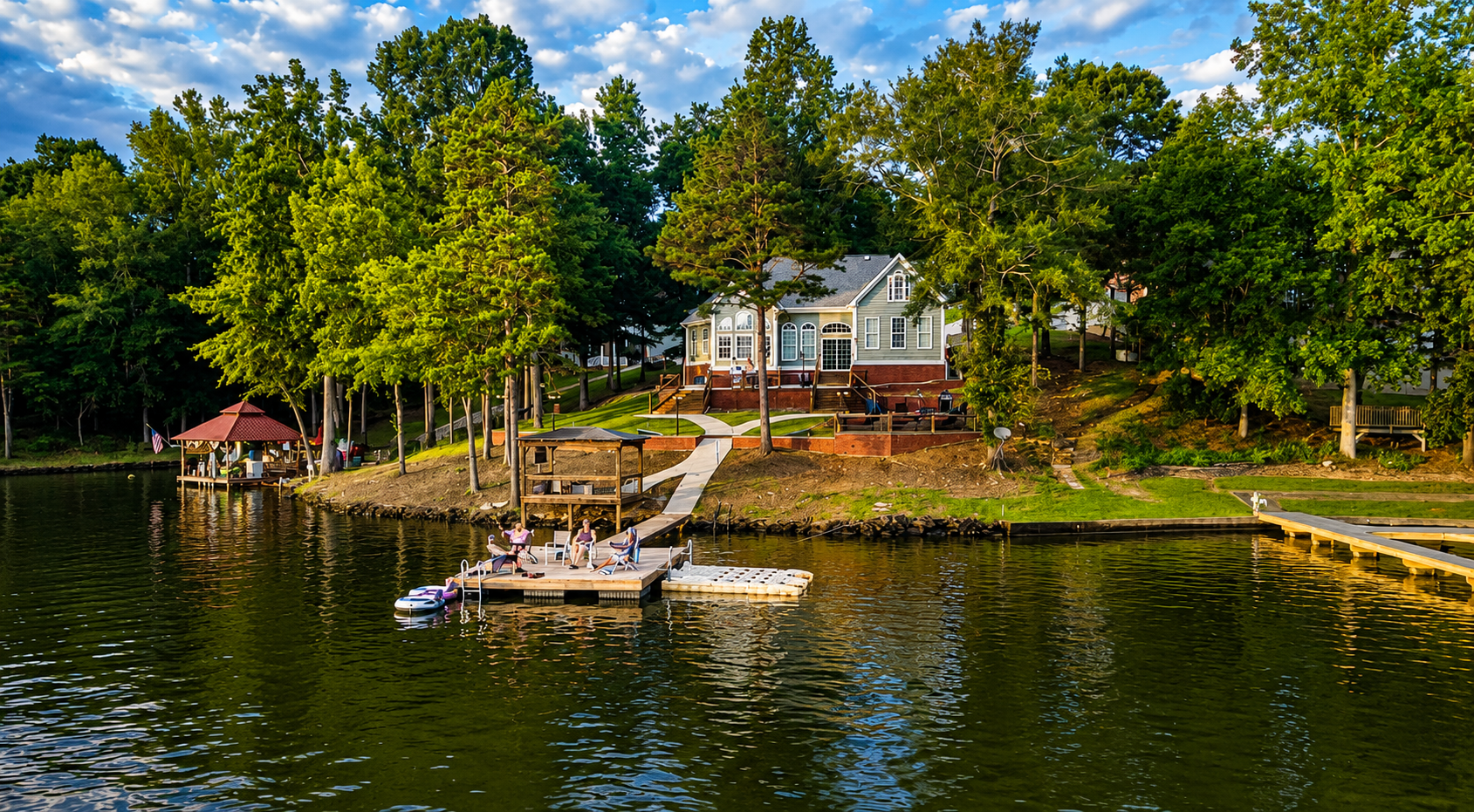 An aerial perspective captured by a drone, showcasing the cabin along with its charming dock and the serene beauty of the lake.