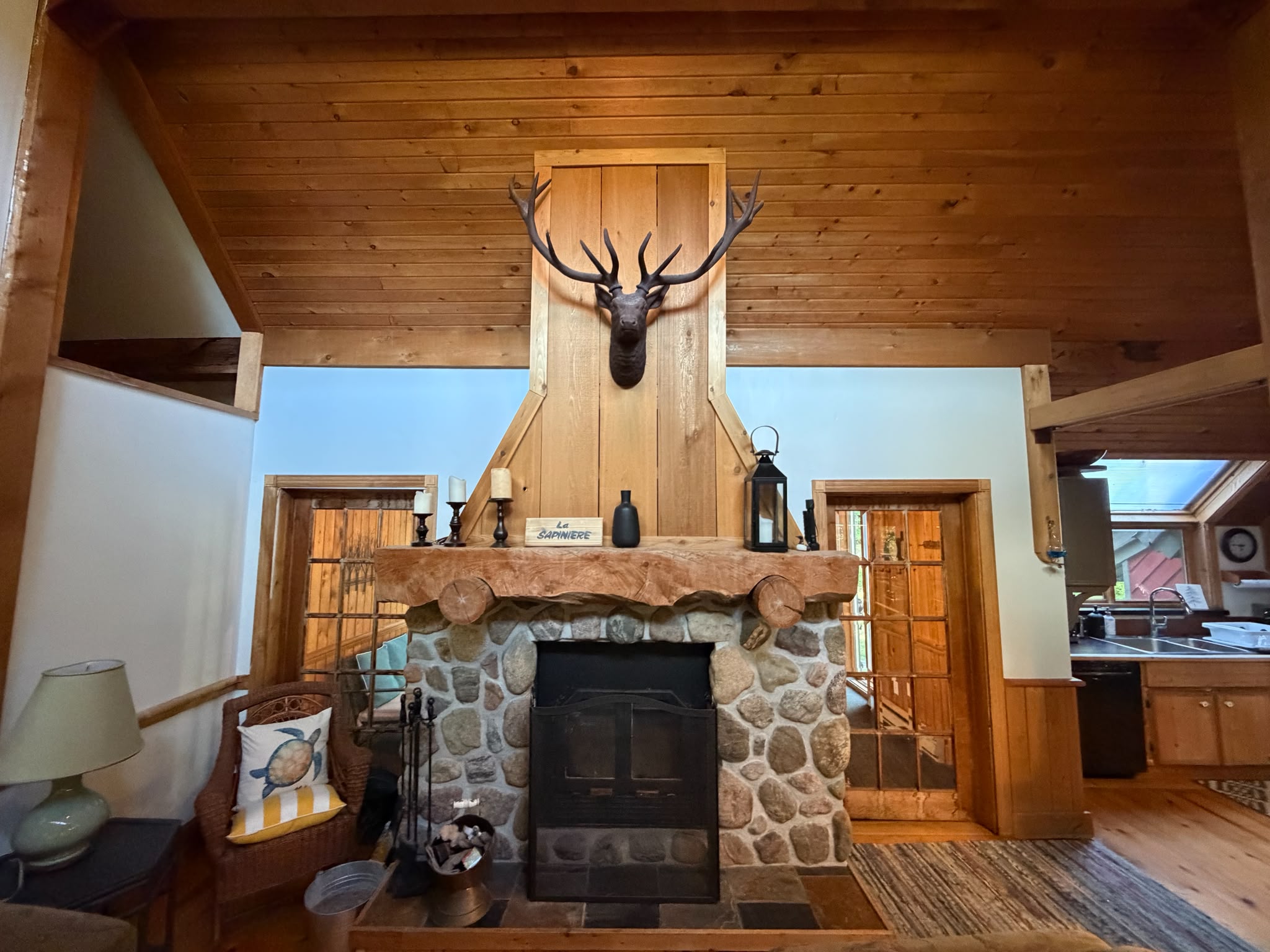 Full view of fireplace with doors to cottage front seating area and cottage entrance