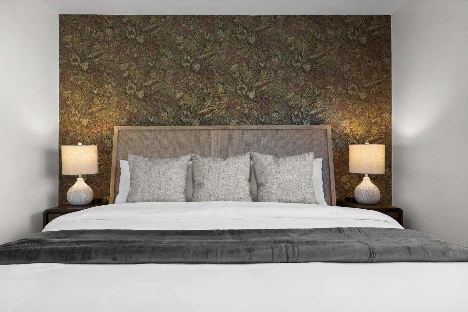 Inviting bedroom with a plush bed, elegant accent wall, and soft bedside lighting—designed for restful sleep and a cozy, relaxing stay.