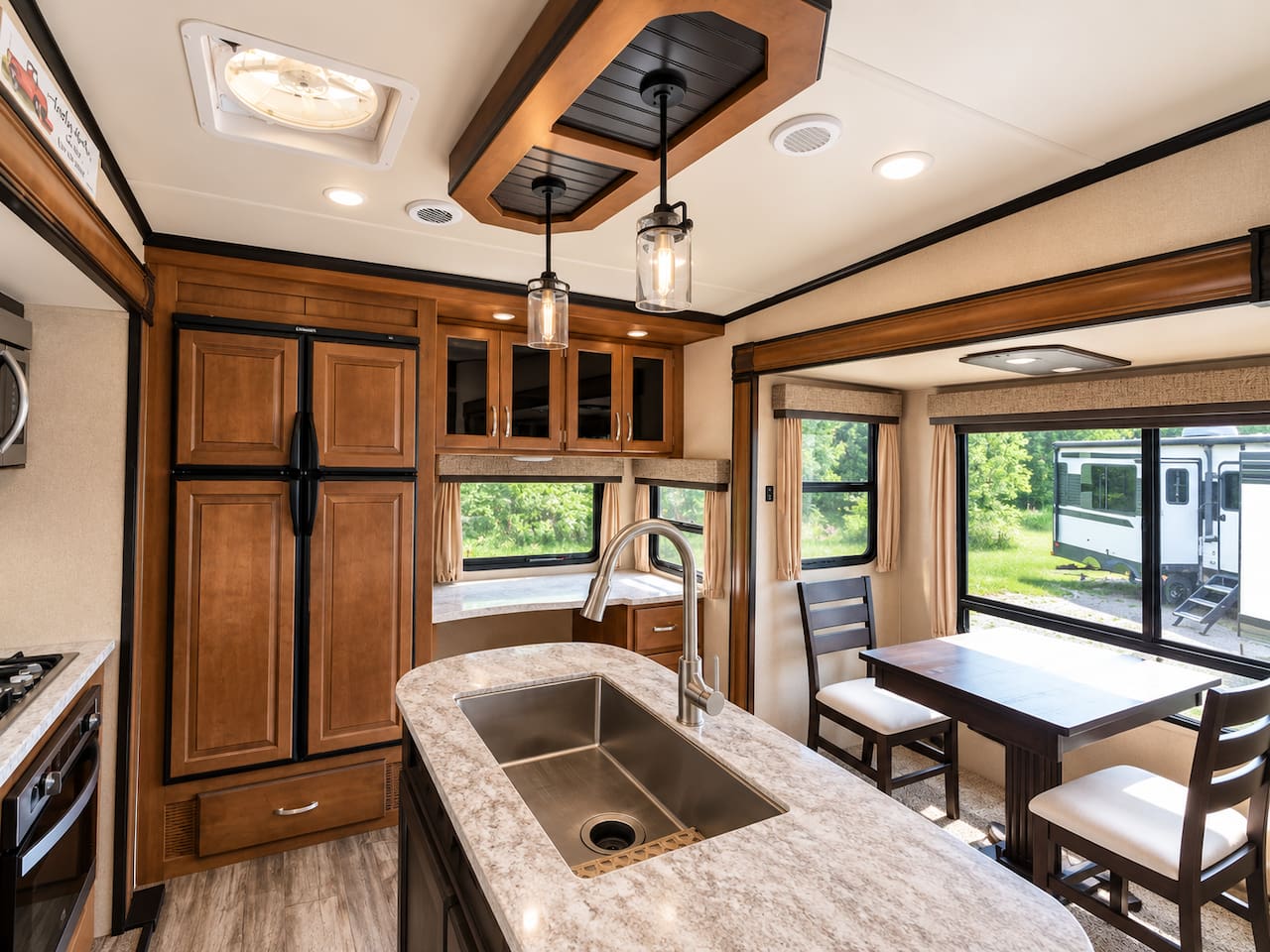 Kitchen and dining area. Kitchen island with sink and solid surface countertops