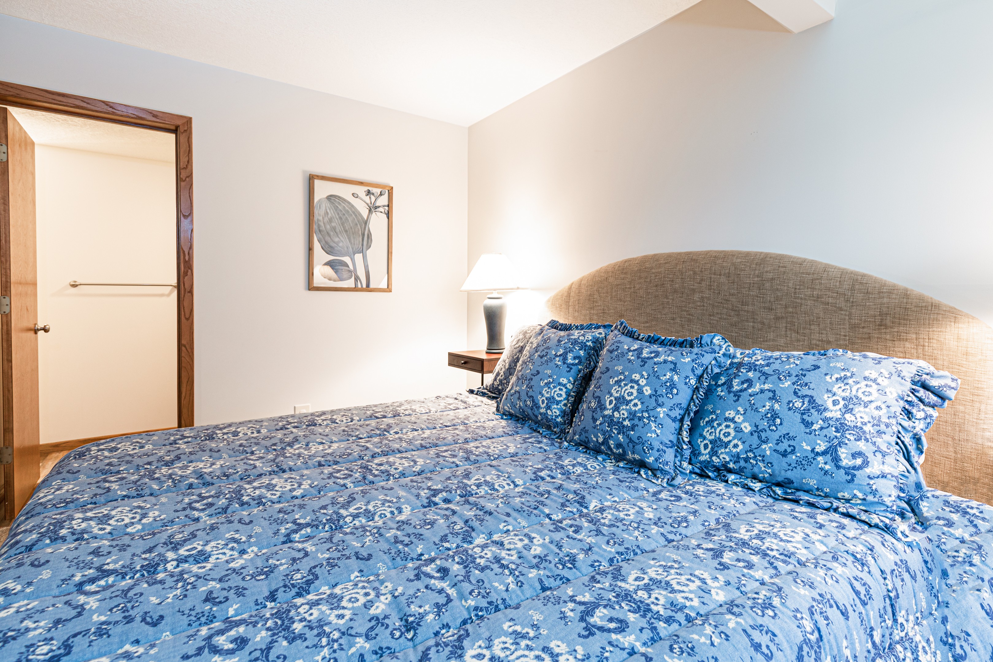 Main level bedroom features a king bed and an ensuite bathroom