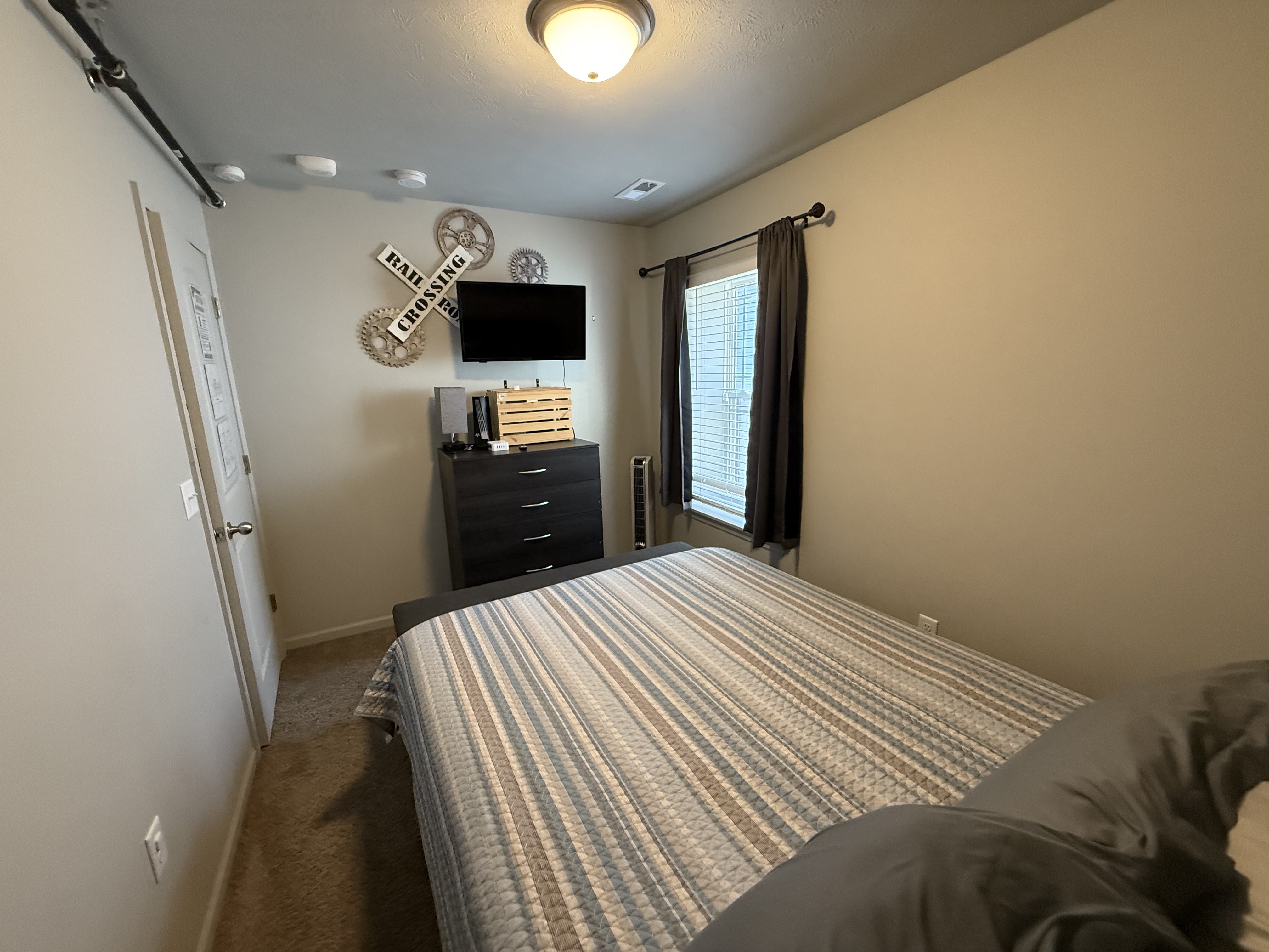 queen bed with 32" streaming tv for relaxing after a busy day