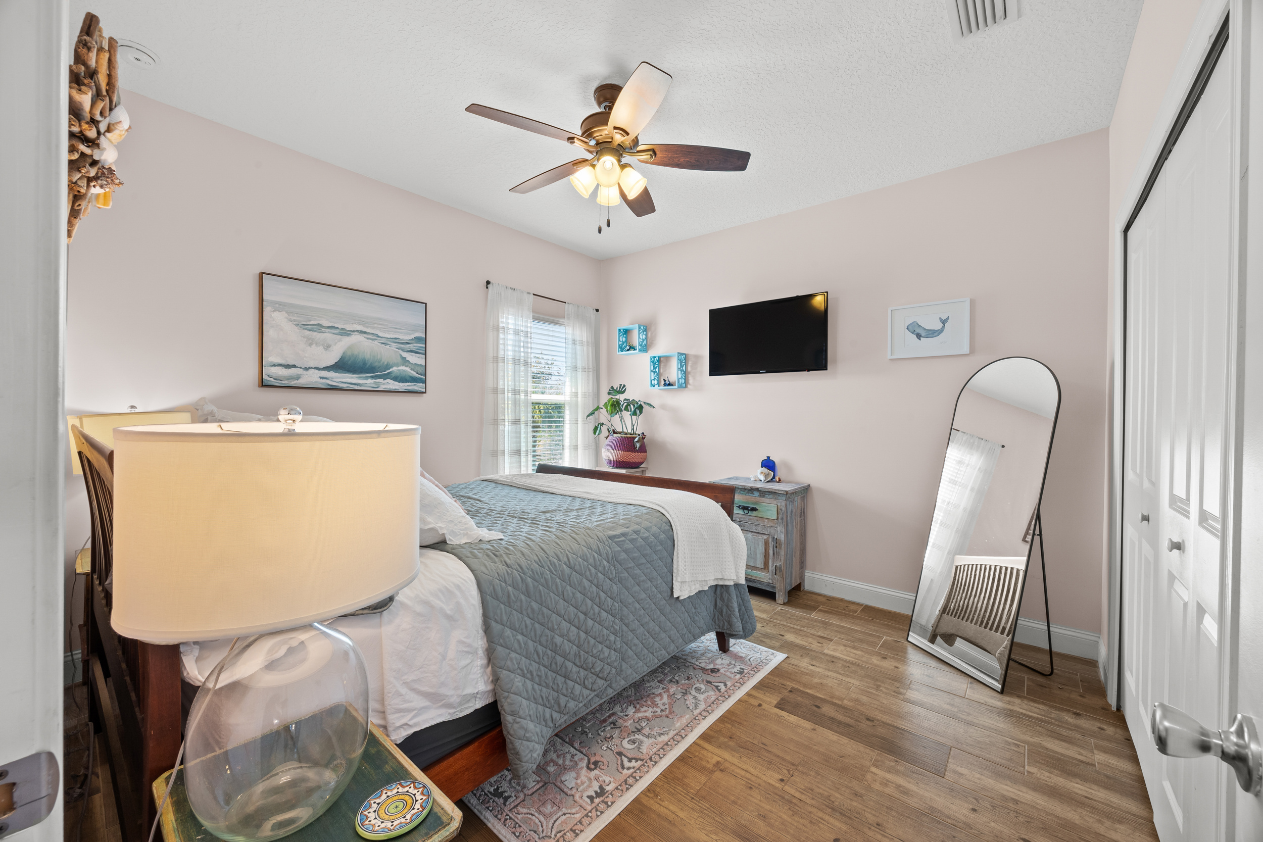 A cozy bedroom retreat with plenty of natural light and comfy bedding.