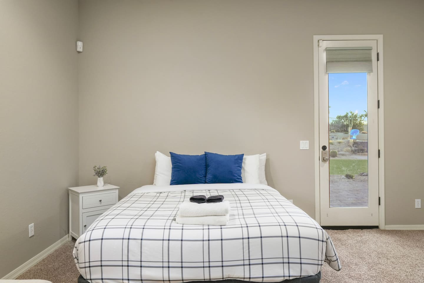 Private casita bedroom with queen bed, backyard access, and abundant natural light.