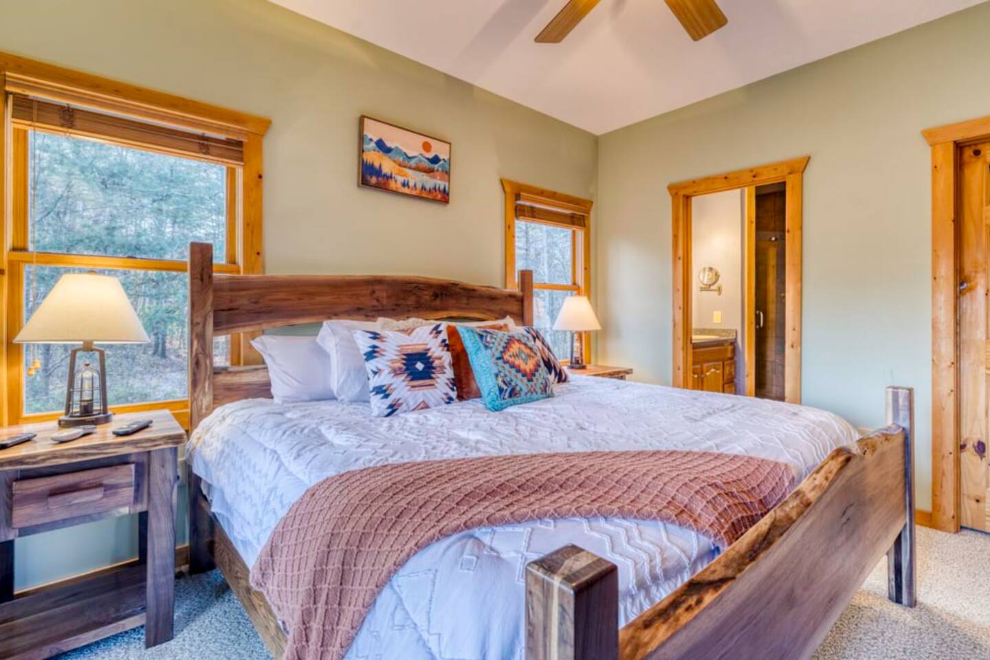 Another perspective of the bedroom with an ensuite bathroom.