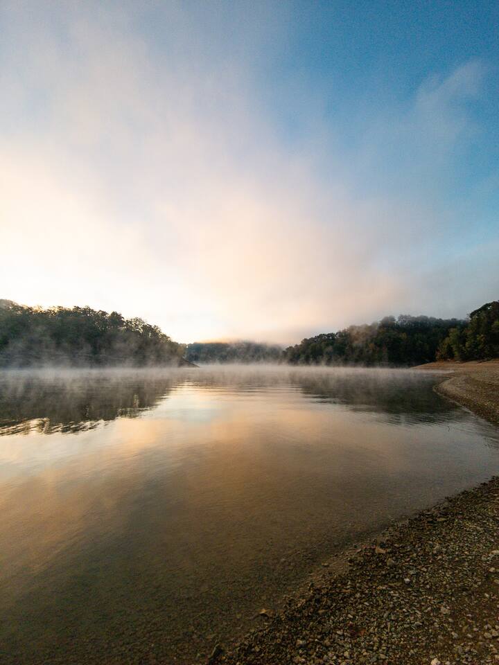 From the shoreline by the boat ramp, witness the lake come alive with morning fog and sunlight.