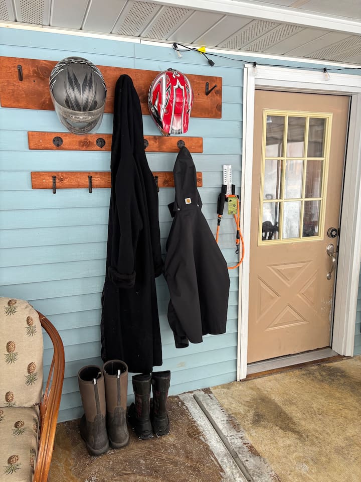 Coat and helmet storage for the large groups. Shelving unit provides more storage to the right of the door.