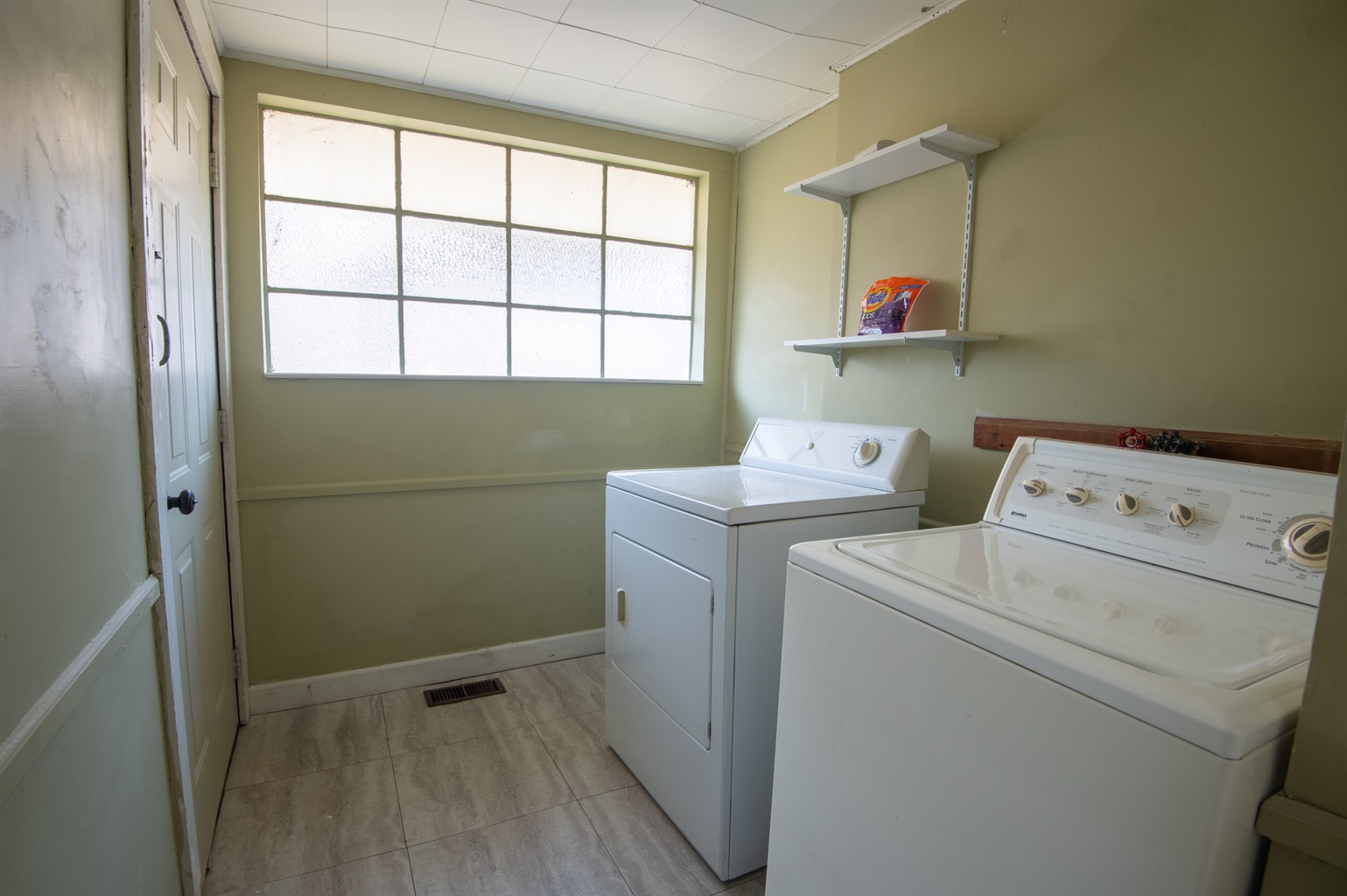 Spacious laundry room equipped with modern appliances and ample storage space, ensuring convenience during your stay.