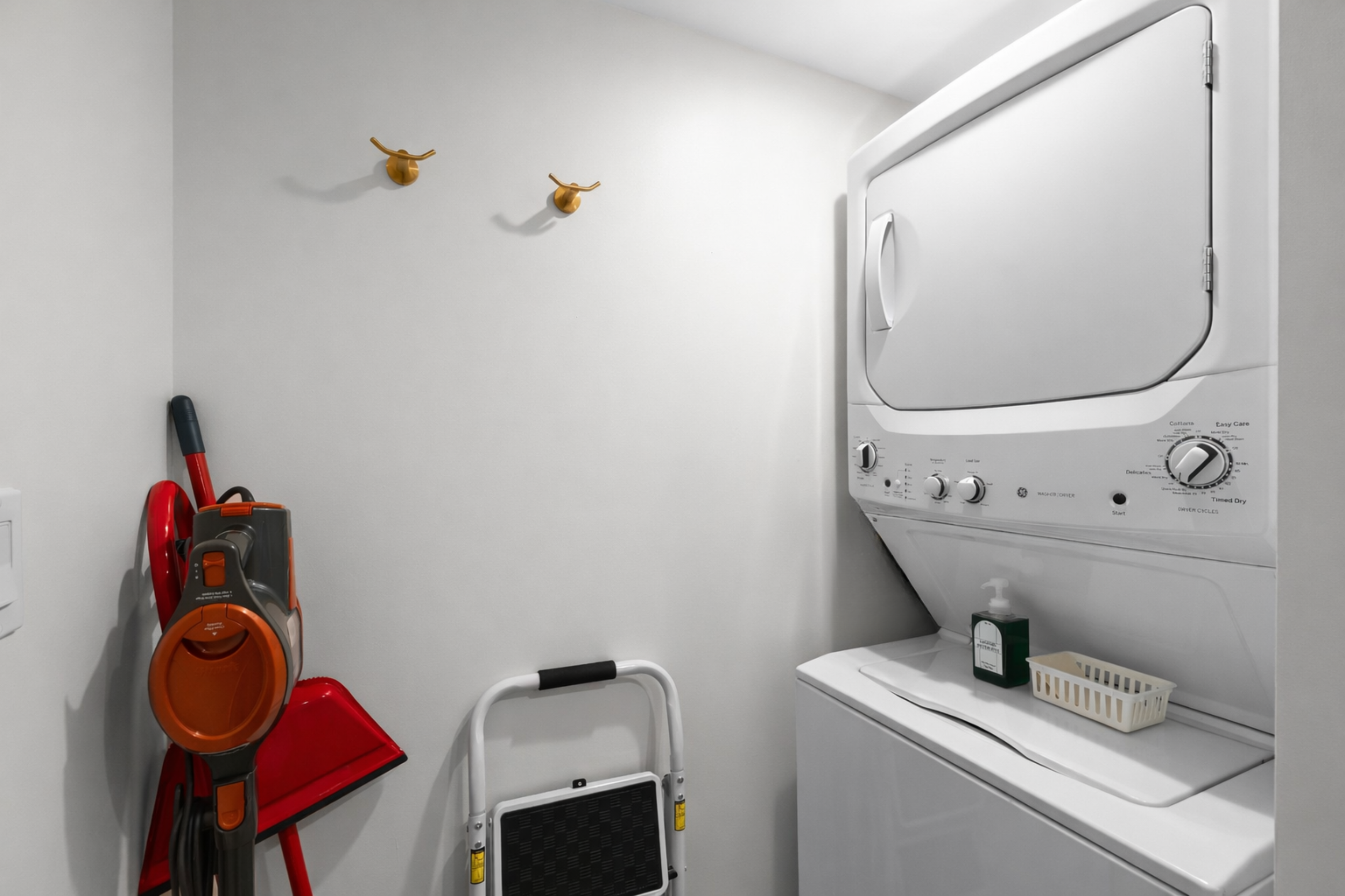 Convenient in-unit laundry area with washer and dryer, plus thoughtfully stored essentials—making longer stays easy and hassle-free.