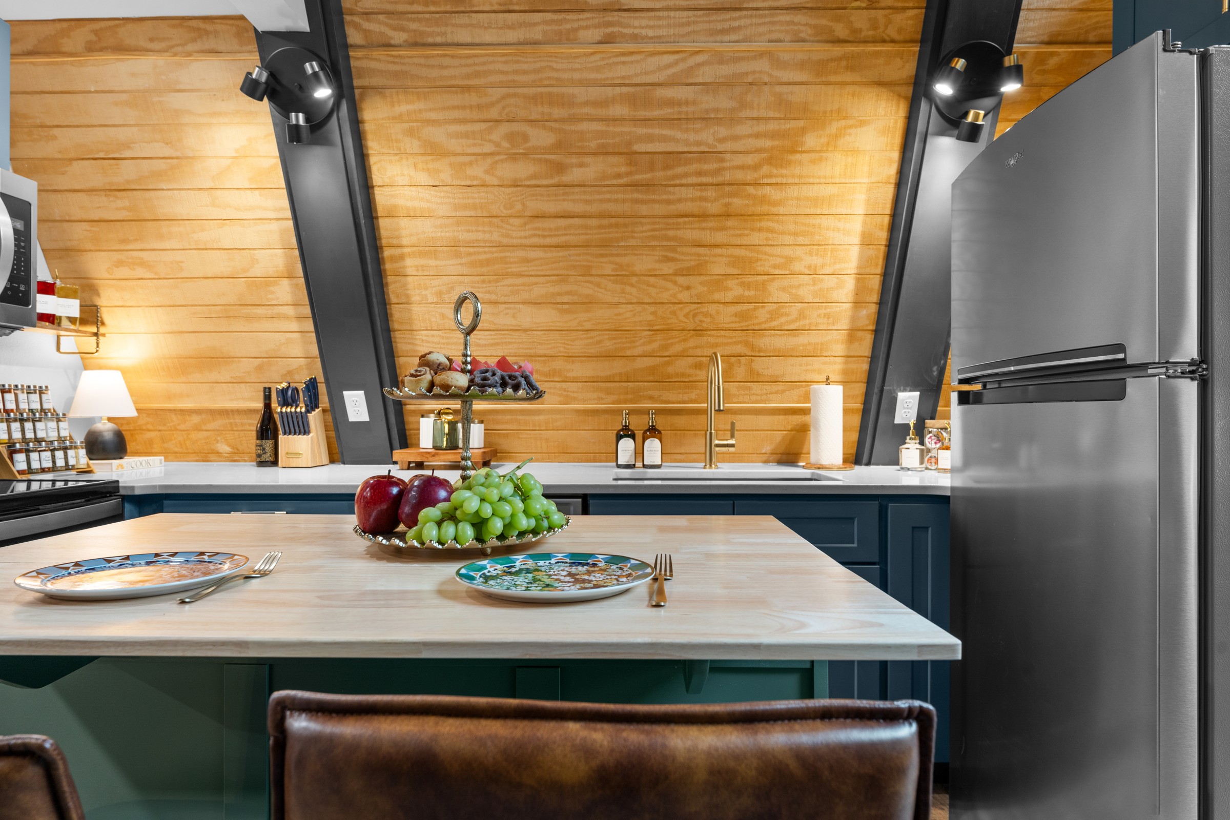 Kitchen island set for two with a fruit stand. Pour something nice, pull up a stool and make dinner a date.