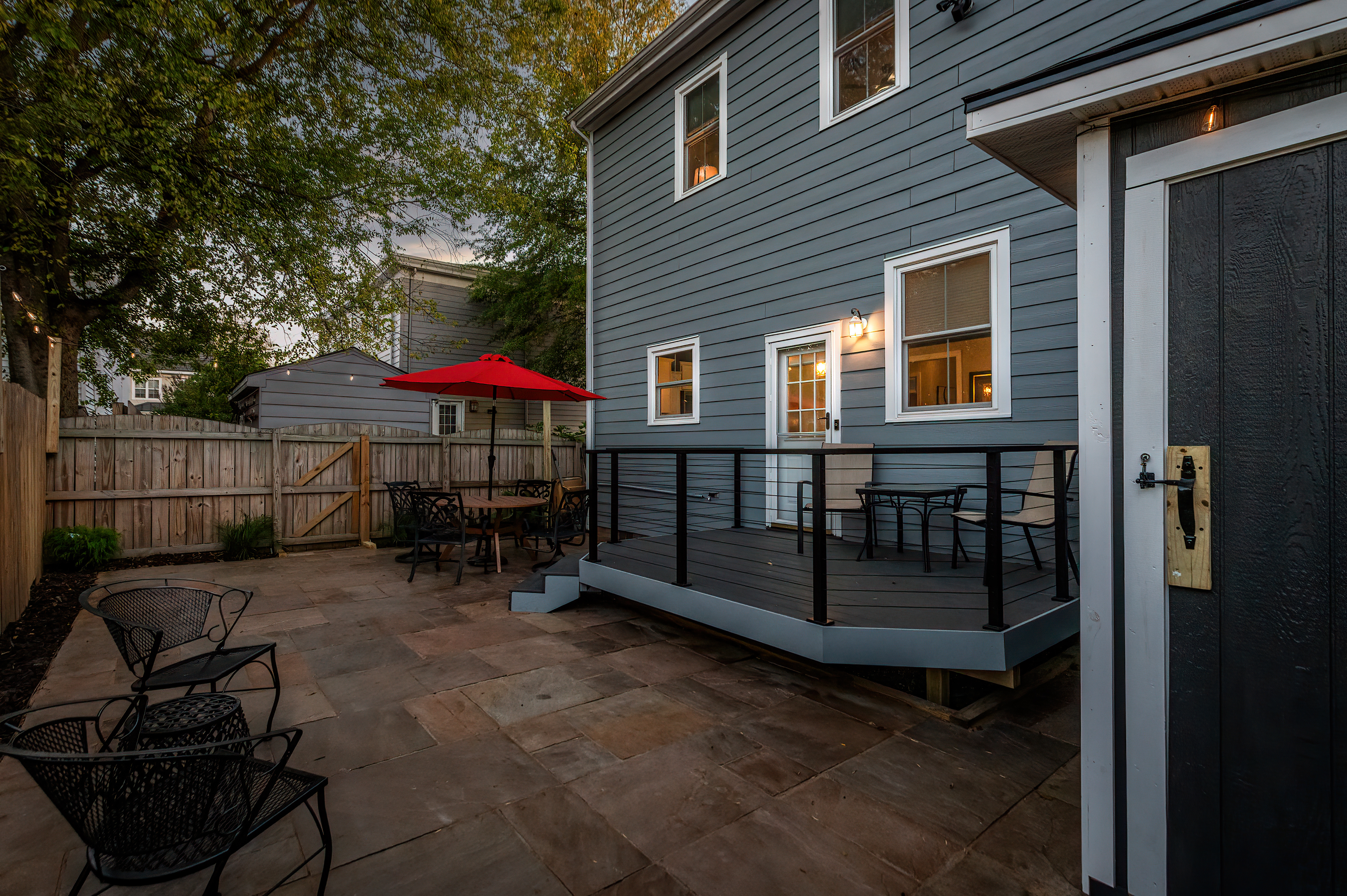 Outdoor Oasis: Enjoy al fresco dining under the red umbrella in your private, fenced patio!