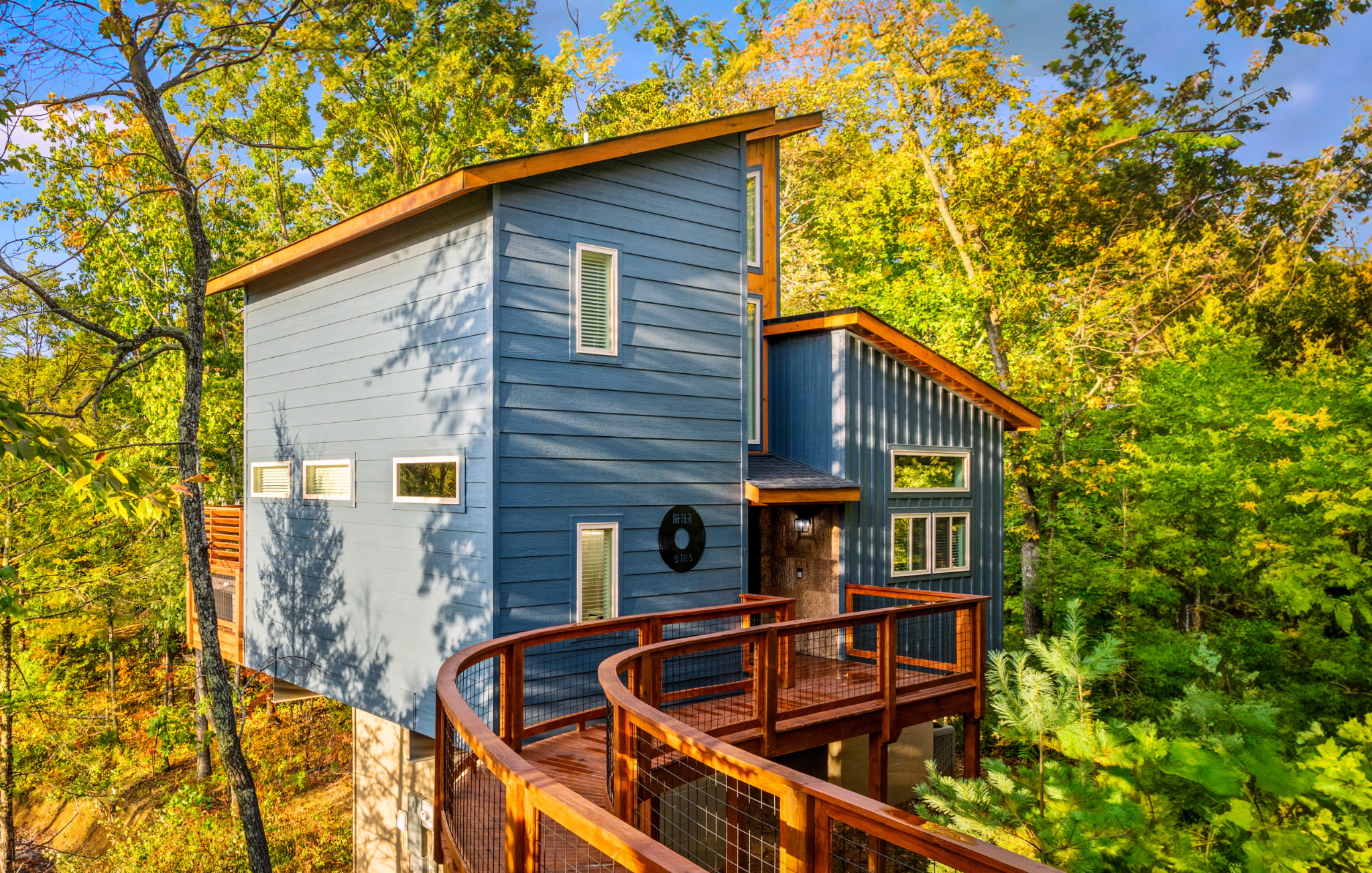 Blue treehouse-style cabin built August 2025 - in-town location with easy road access, no white-knuckle mountain switchbacks or nerve-wracking drives. Walk up and check in.