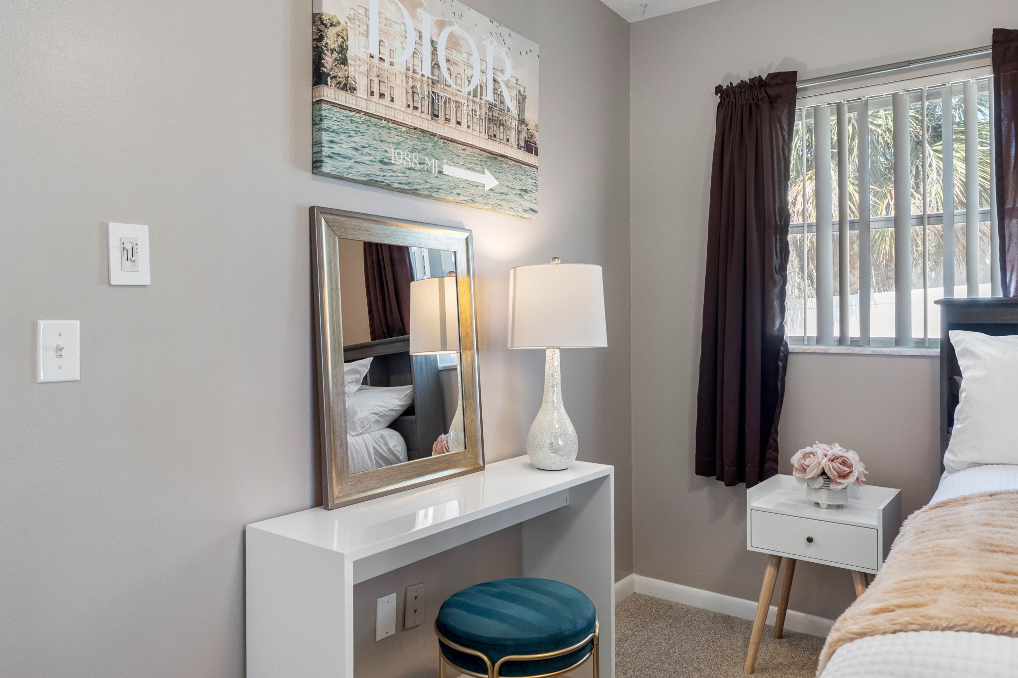 Large mirrored closets reflect natural light, making the room feel even more spacious and bright.