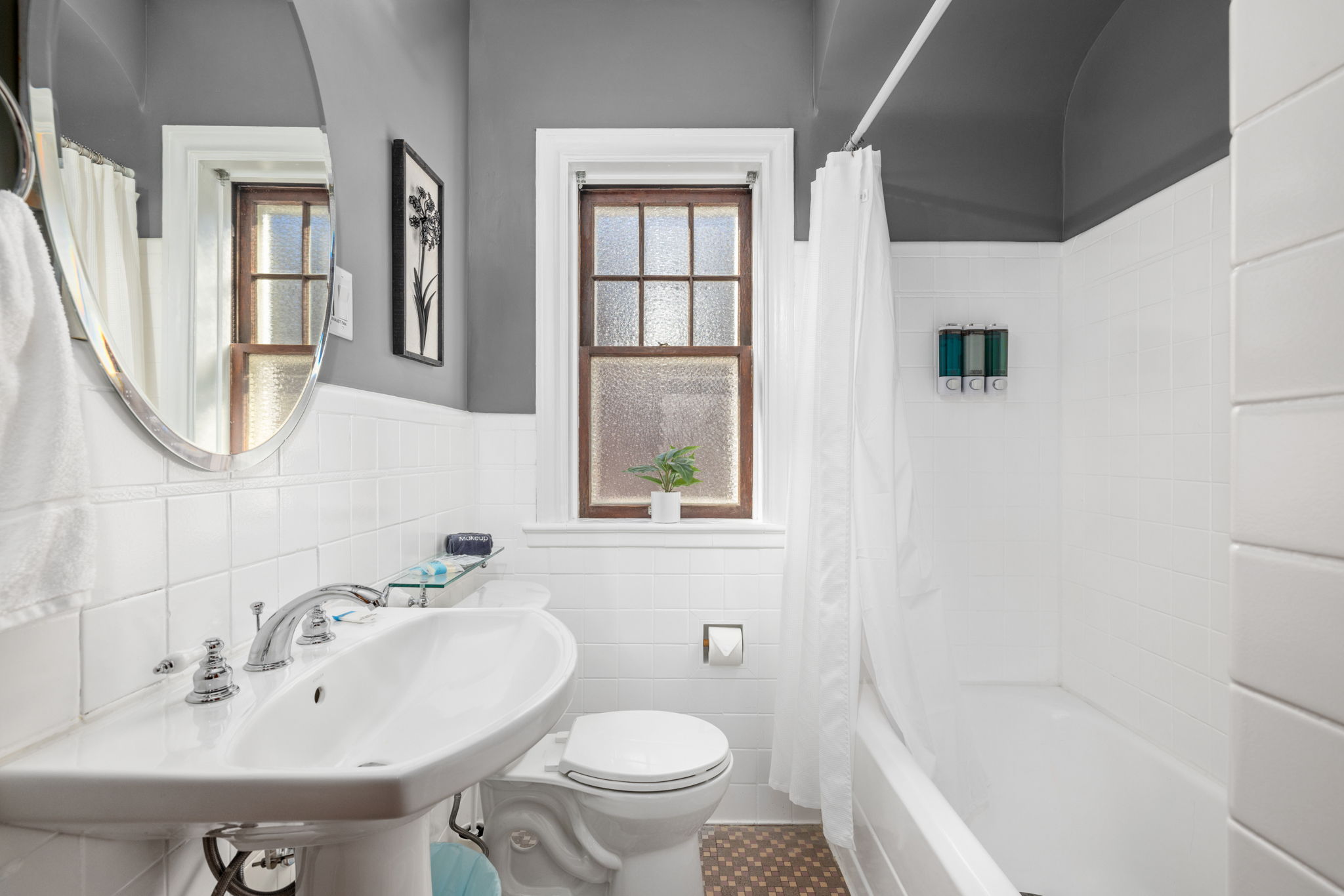 Main level bathroom with medicine cabinet, closet, and hair dryer.  Soap, body wash, shampoo, conditioner provided.