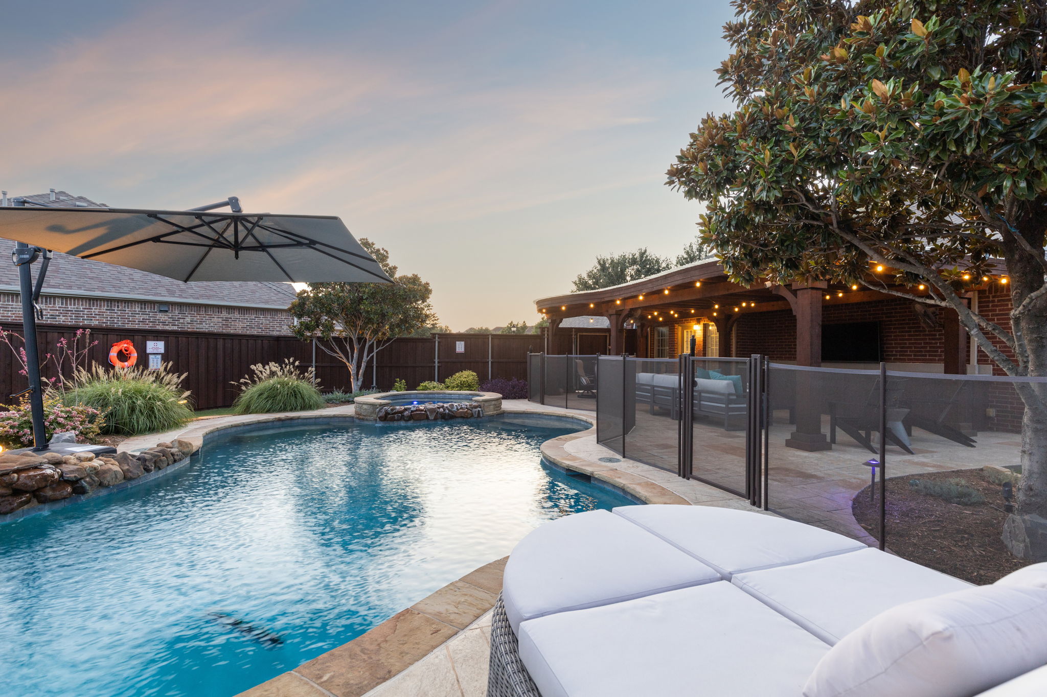 Secluded backyard oasis with gated pool, spa, and pergola.