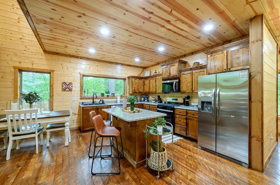Rustic gourmet kitchen with spacious island and warm cabin charm