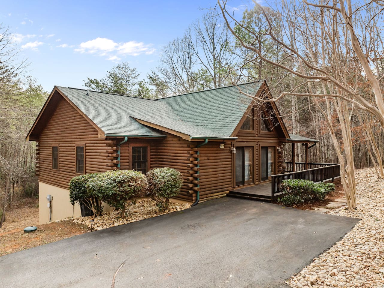 Front view of the cabin with paved driveway