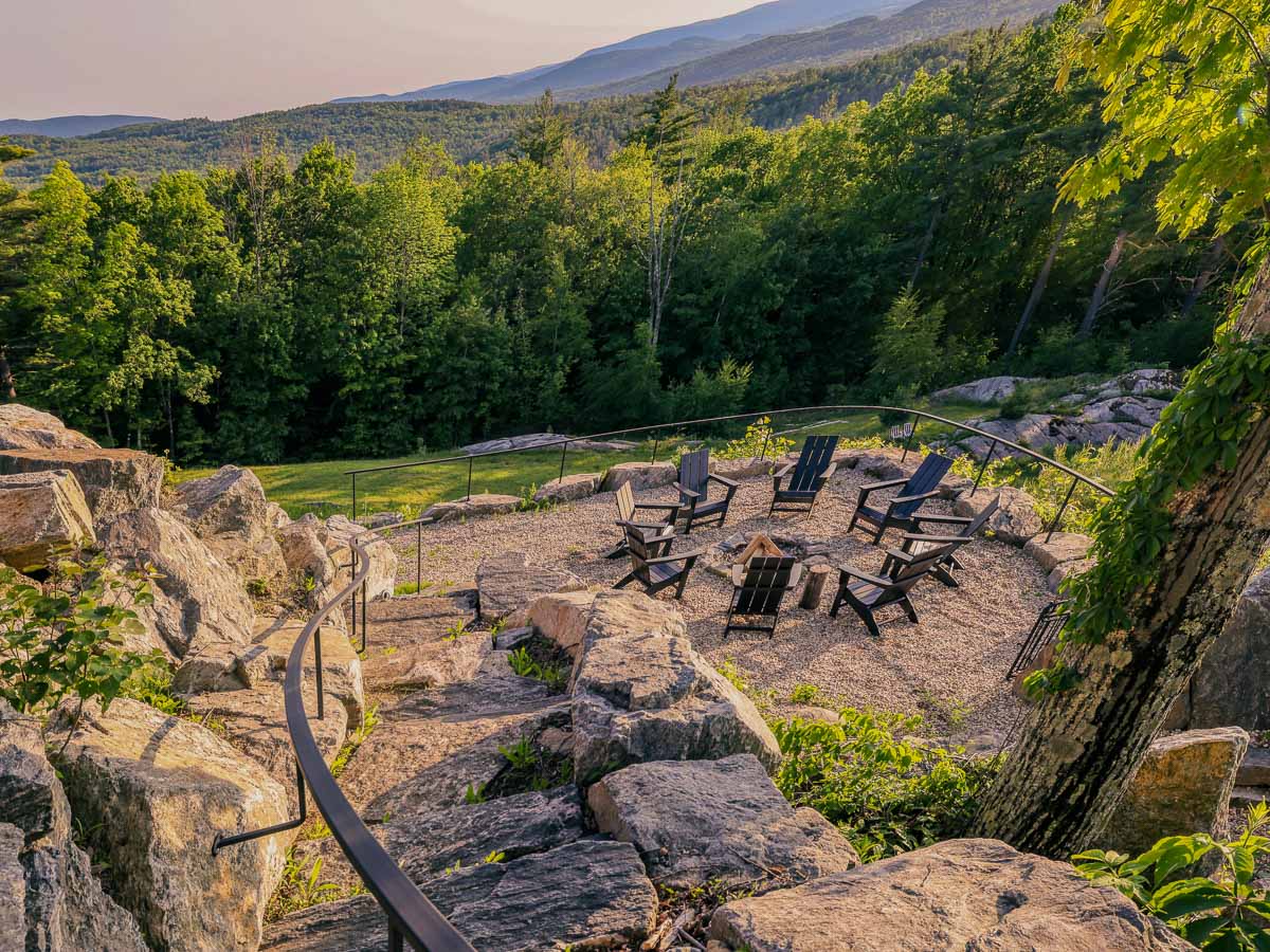 Adirondack chairs around the fire pit on the rocks with summer valley view &mdash; Sunset Falls Berkshires
