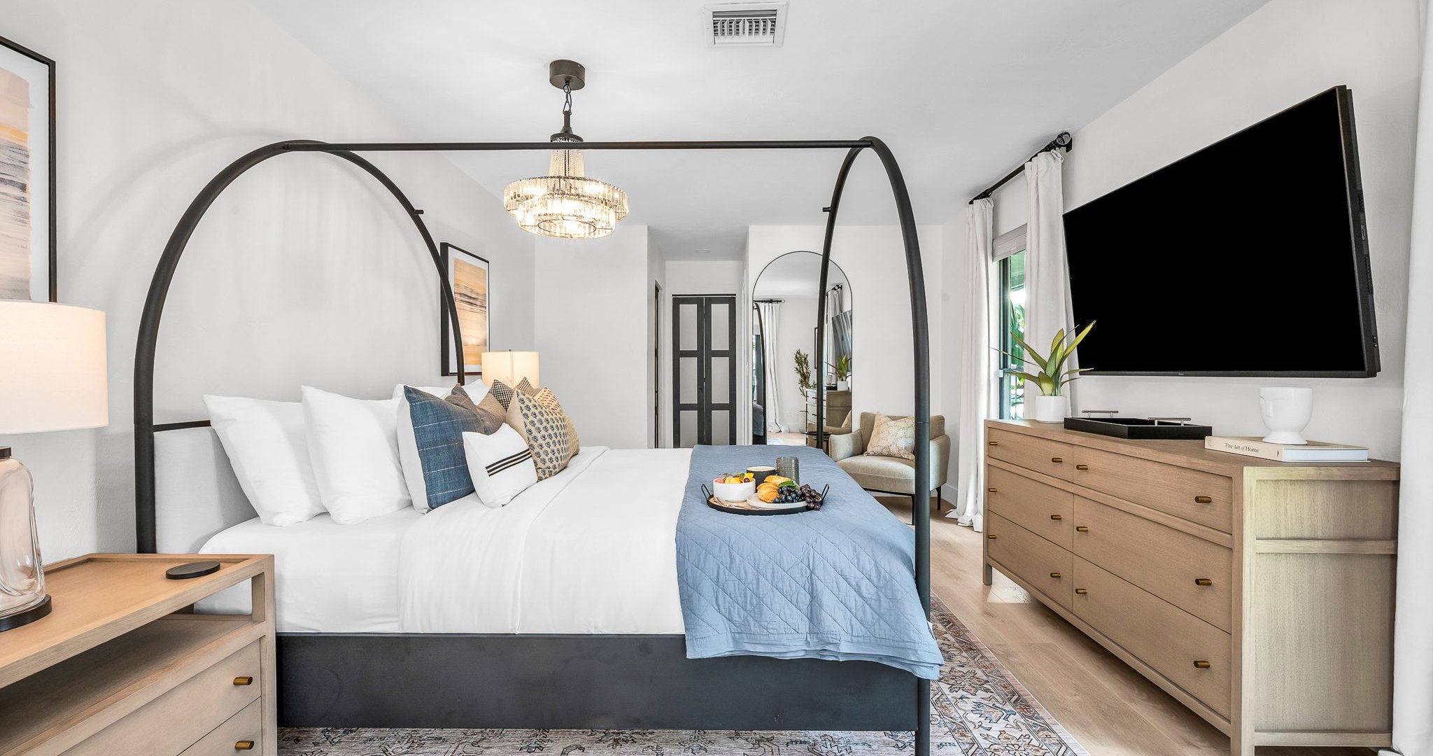 This second primary suite offers a plush king bed, private ensuite bathroom, and walk-in closet for added comfort. Enjoy poolside views and direct access to the outdoor living area, making it the perfect blend of luxury and convenience.