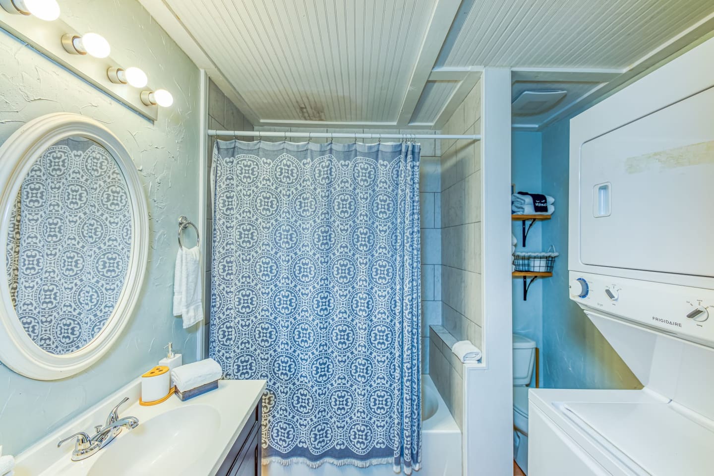 Bathroom Retreat: Bright and stylish space with modern fixtures and a convenient laundry area!