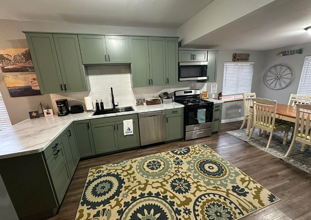 HOUSE WITH WHITE PORCH: New kitchen cabinets, countertops, and appliances March 2026. No more wall between the kitchen and living room. 