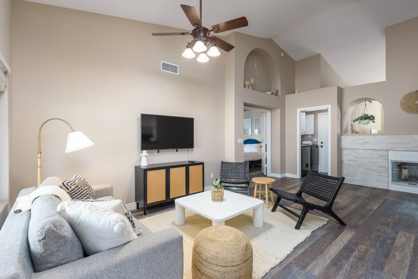  Sitting area with wall-mounted TV, comfortable seating, ceiling fan, and patio door access for relaxed downtime.