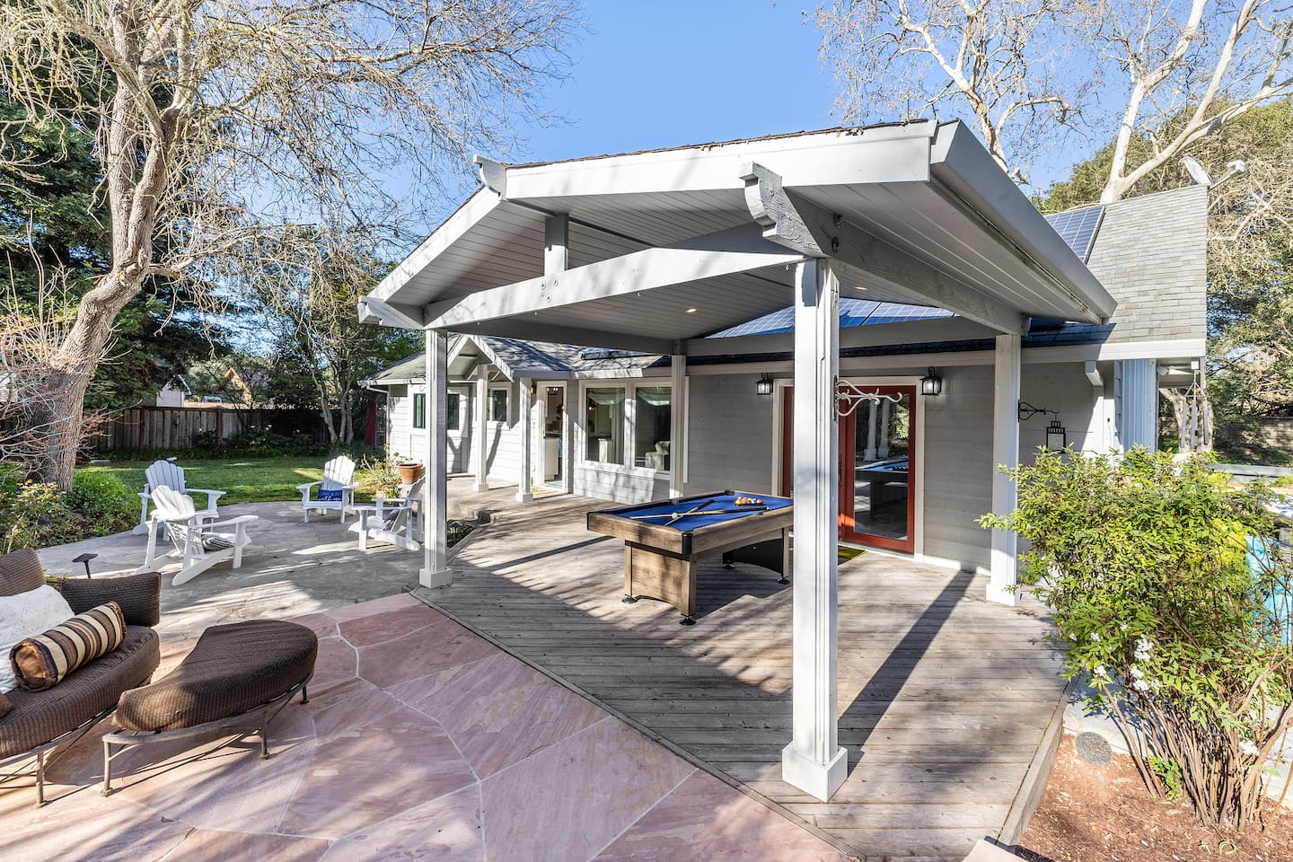 Just outside the living room and kitchen doors is a pool table and seating area with a large comfy lounger and four additional chairs.