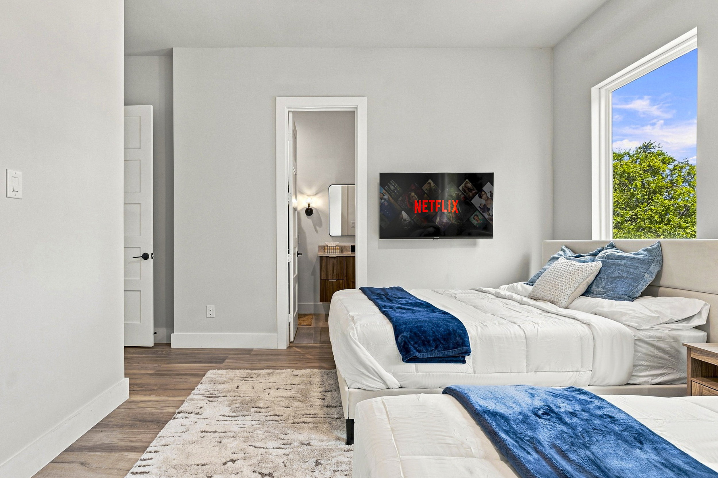 Bright room with two beds, modern decor, and a view for total relaxation!