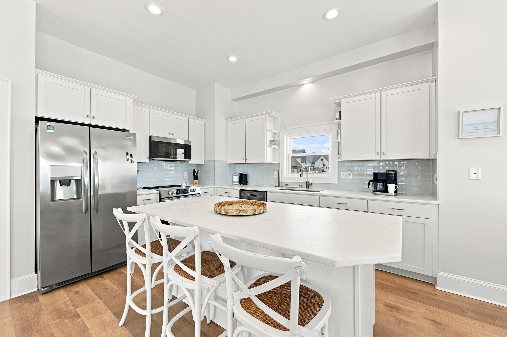 Island seating for three creates the perfect spot for breakfast, beach snacks, and vacation chats.