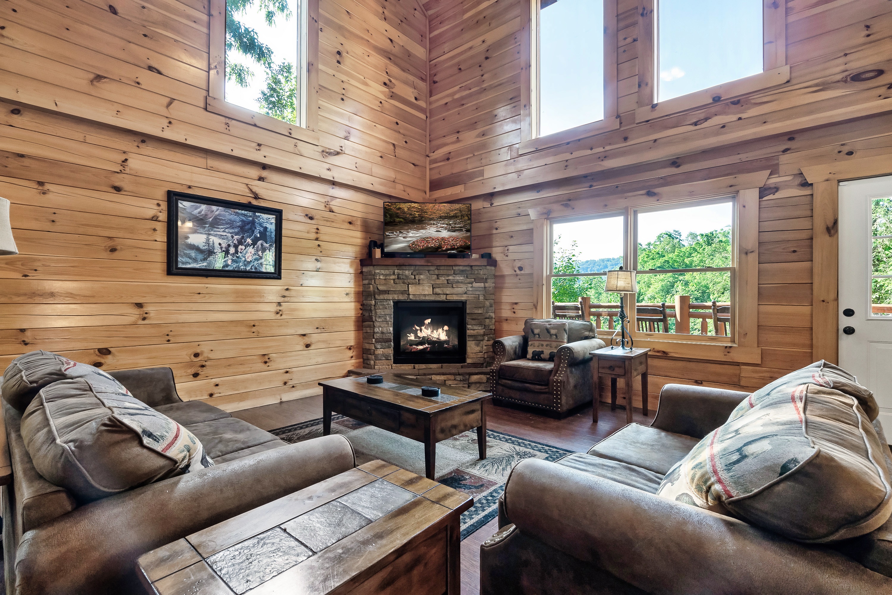 Sink into the soaring, sun drenched living room where vaulted ceilings and warm wood create instant cabin wow.
