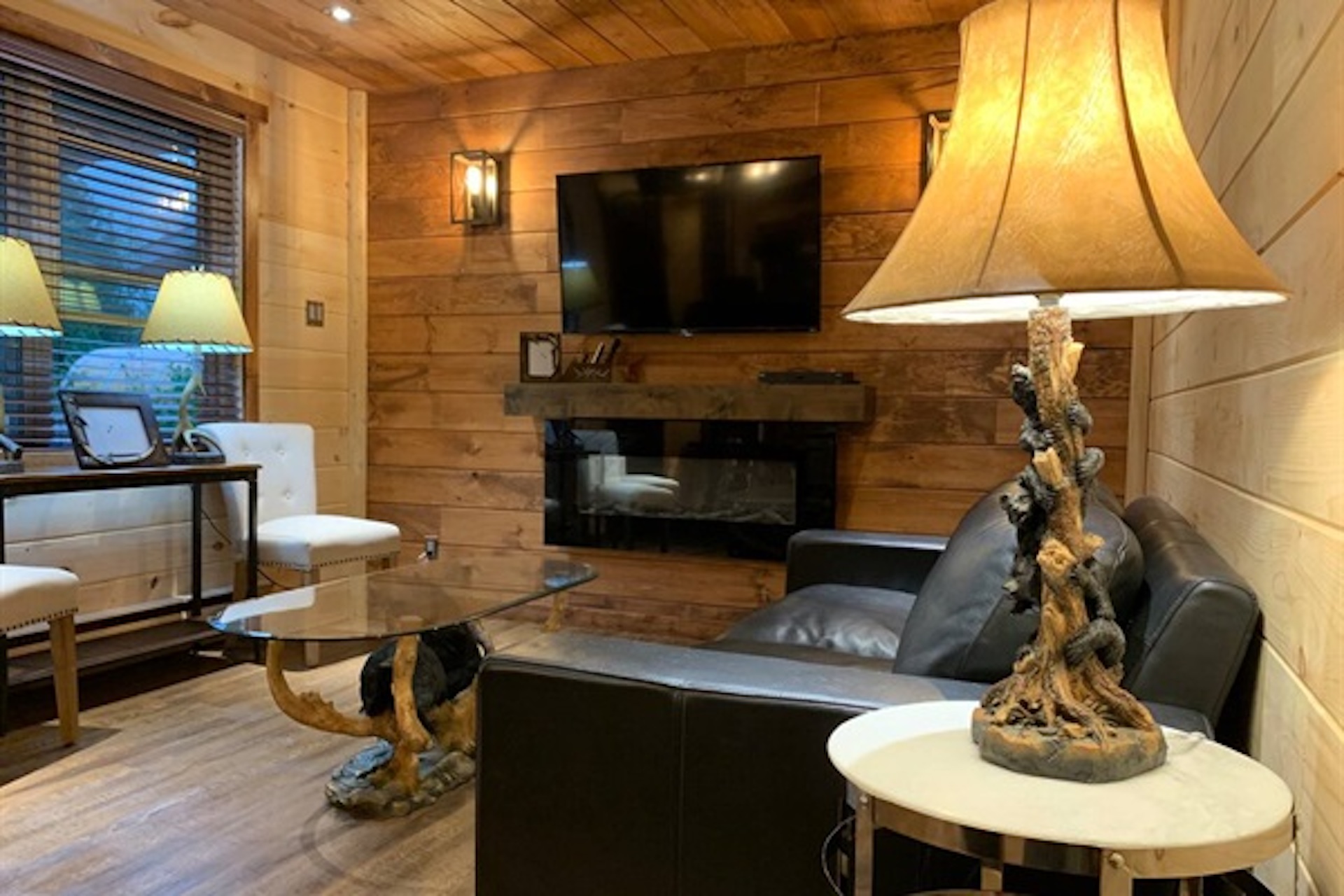 Open living area with fireplace and warm lodge-style finishes