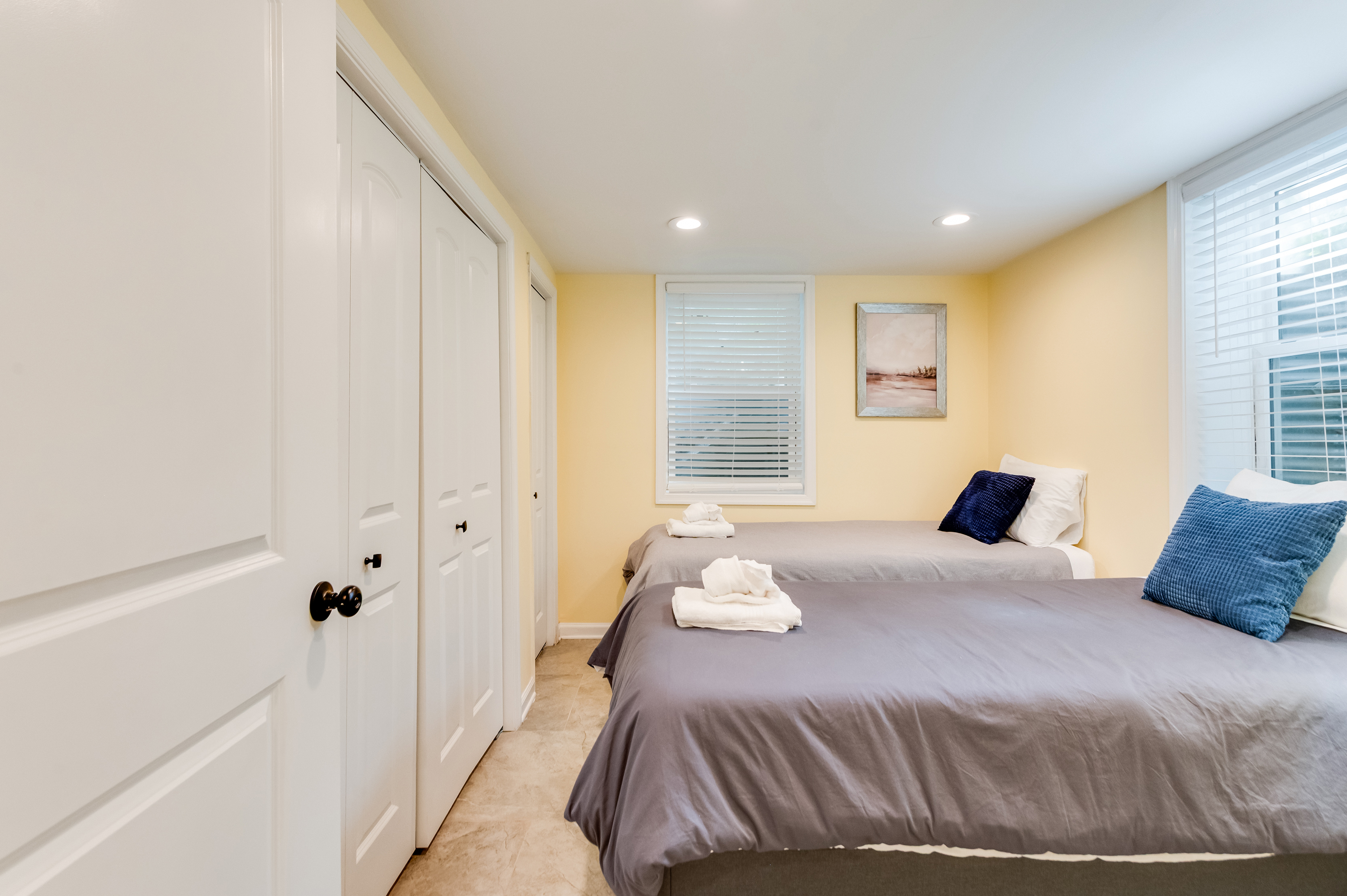 Downstairs Twin Bedroom 3: Bright twin beds with cheerful decor, perfect for a fun getaway in Quinton!