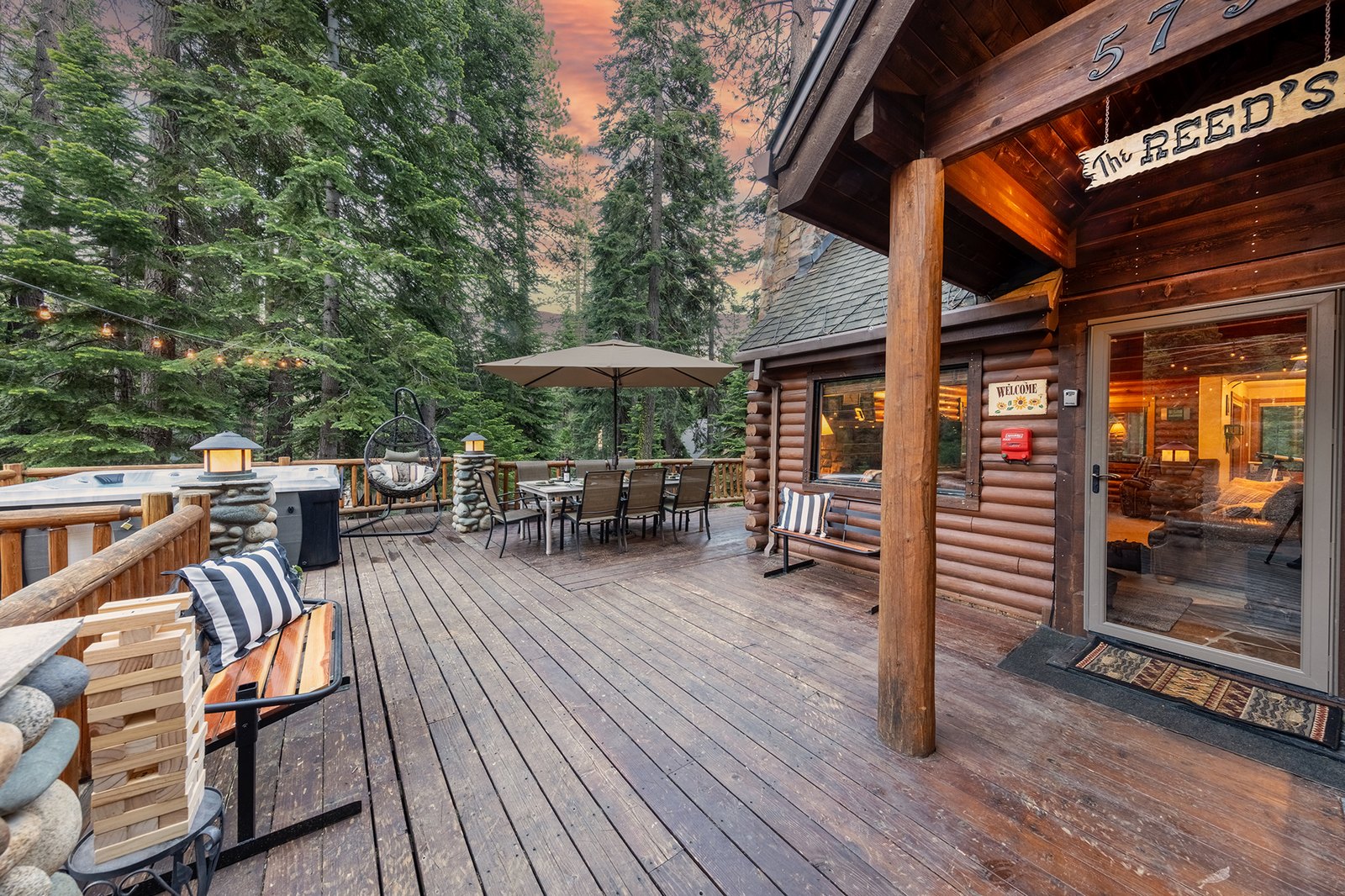 Step right out from the great room onto the deck — hot tub, two dining tables, and the fire pit lounge all a few steps from the door.