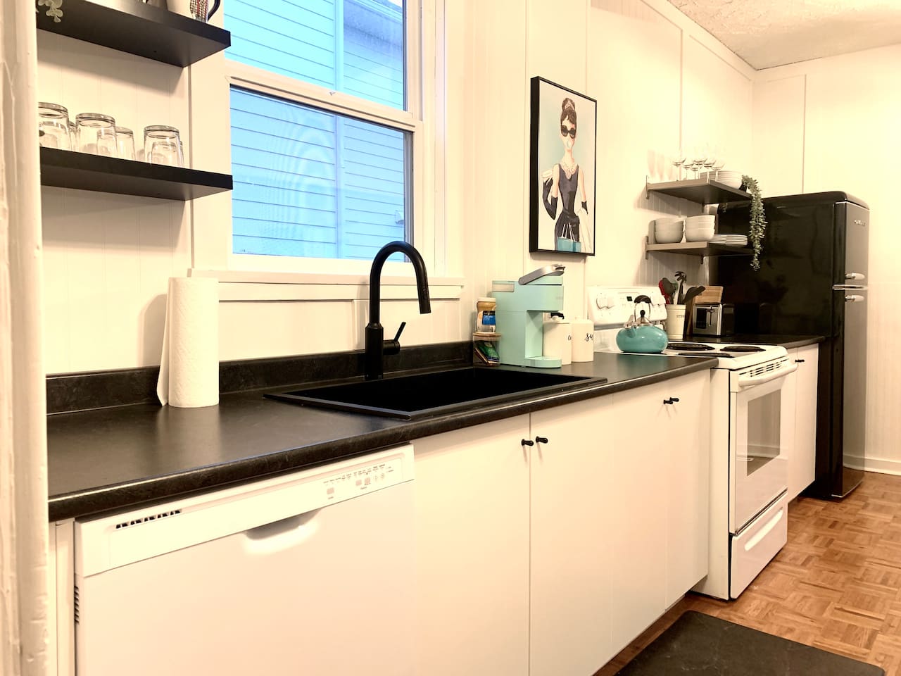 Fully equipped kitchen with stove, microwave, coffee maker, cookware, and dining essentials.