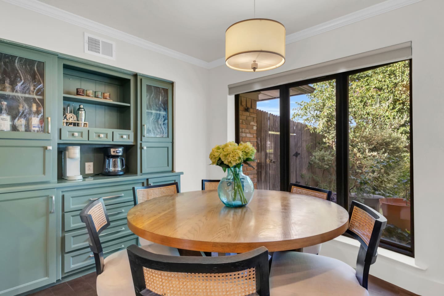 Charming kitchen nook set beside the coffee bar, offering an inviting space to enjoy slow mornings, casual bites, or a fresh cup of coffee while staying connected to the open kitchen and living area.
