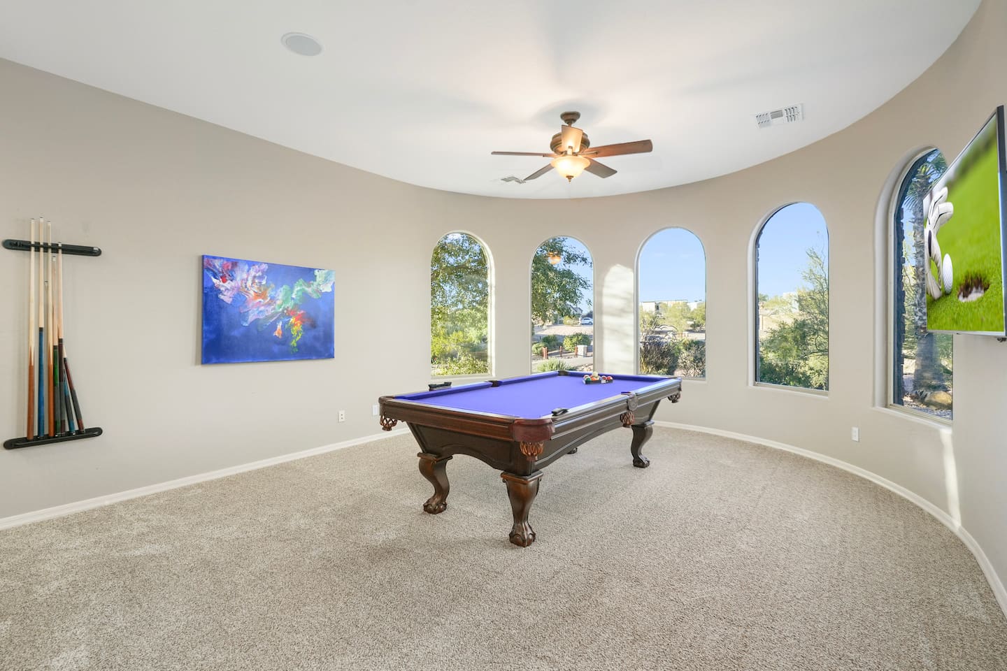 Enjoy games and entertainment with a wall-mounted TV positioned perfectly for viewing while playing pool.