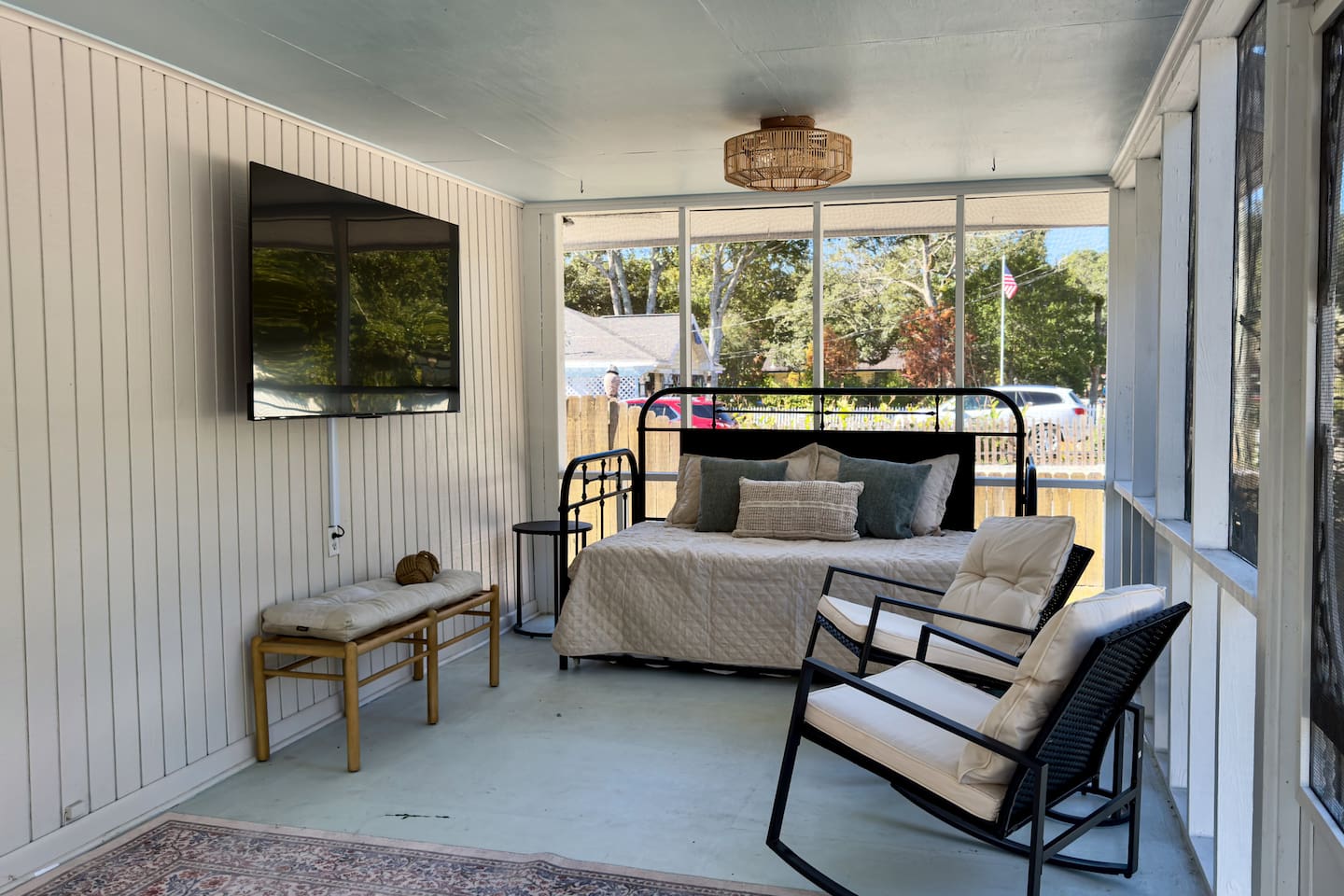 Fresh Air! Relaxing screened porch with daybed seating, cozy chairs, and a wall-mounted TV.