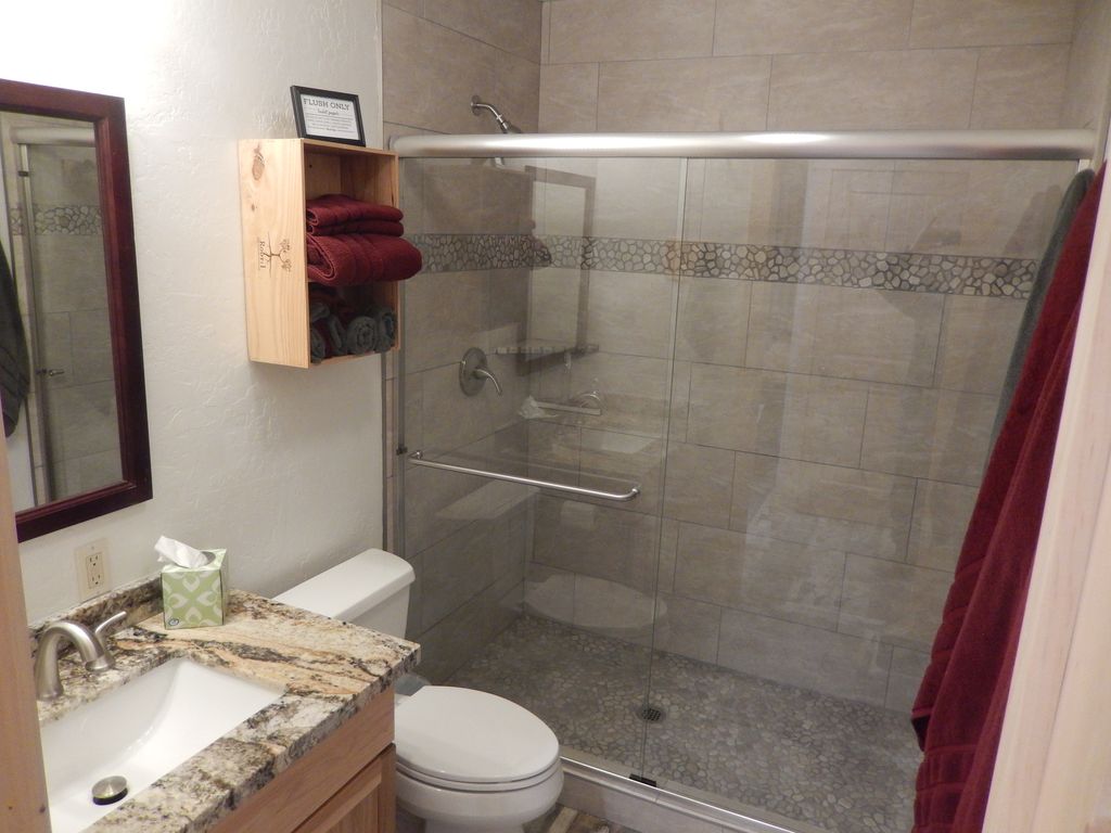 Hall bath on Main level stone shower flooring and new tile. Its beautiful!
