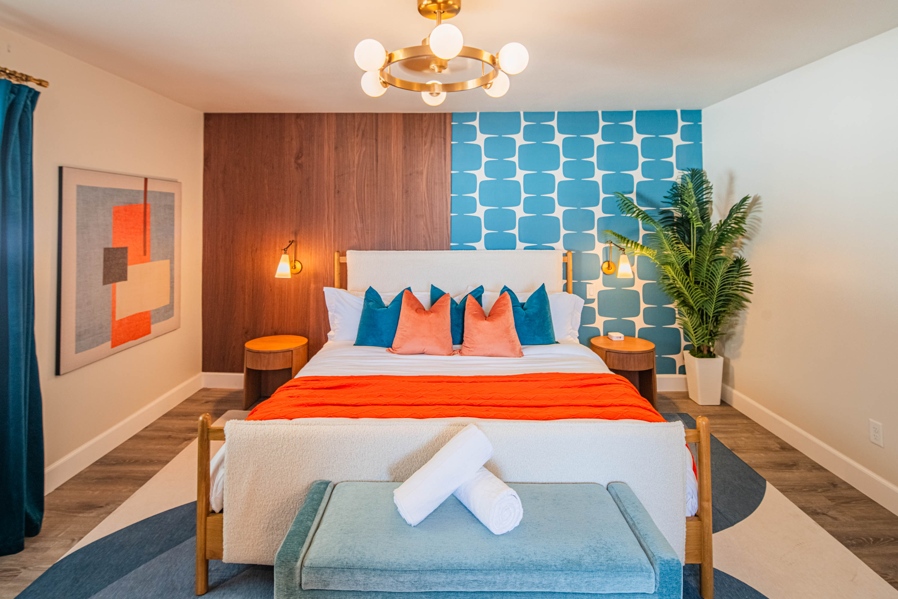 Relax in the primary bedroom featuring a king bed, modern décor, plush linens, and a calm retreat feel after a full day exploring Scottsdale.