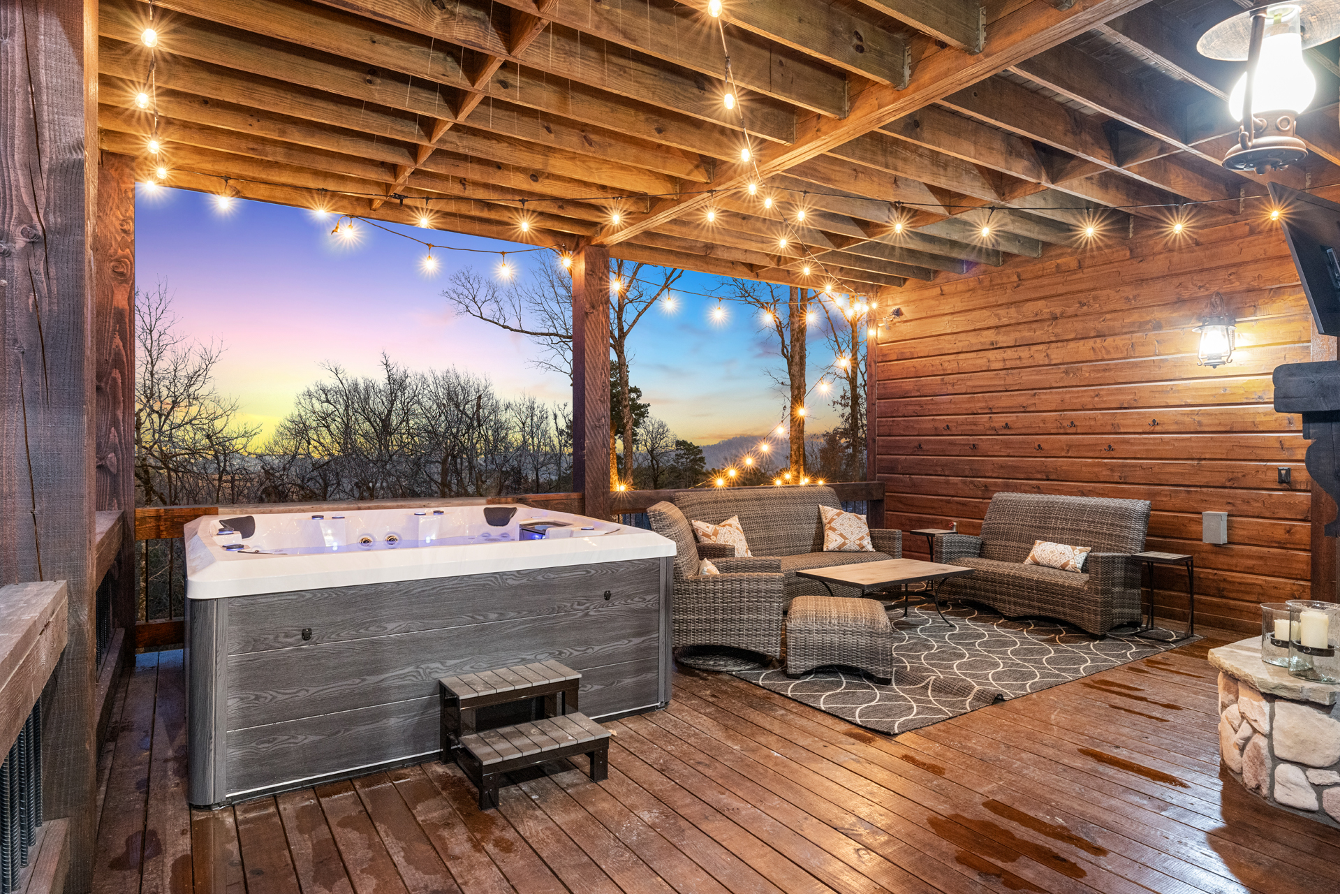 Private hot tub retreat with cozy lounge seating and glowing evening lights