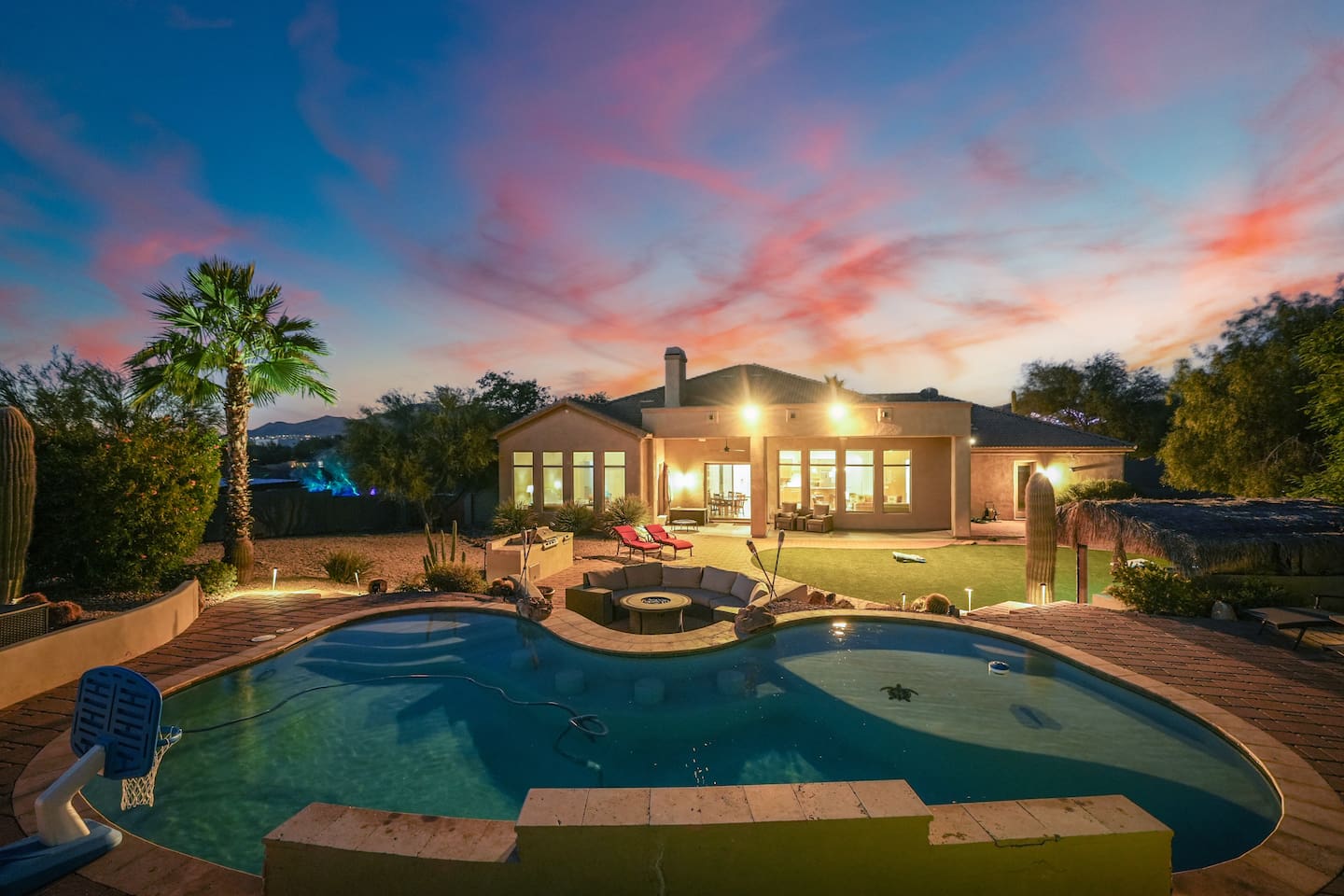 Evening pool ambiance with warm lighting and stunning sunset colors.