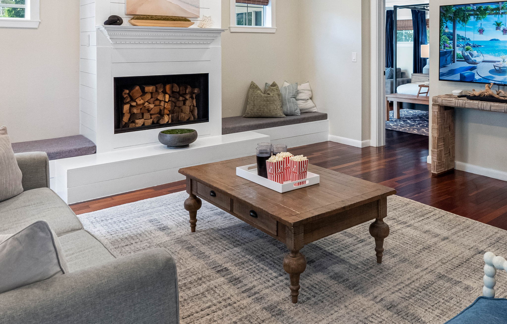 The shiplap fireplace, complete with built-in seating on each side, serves as a striking focal point of this charming living area.