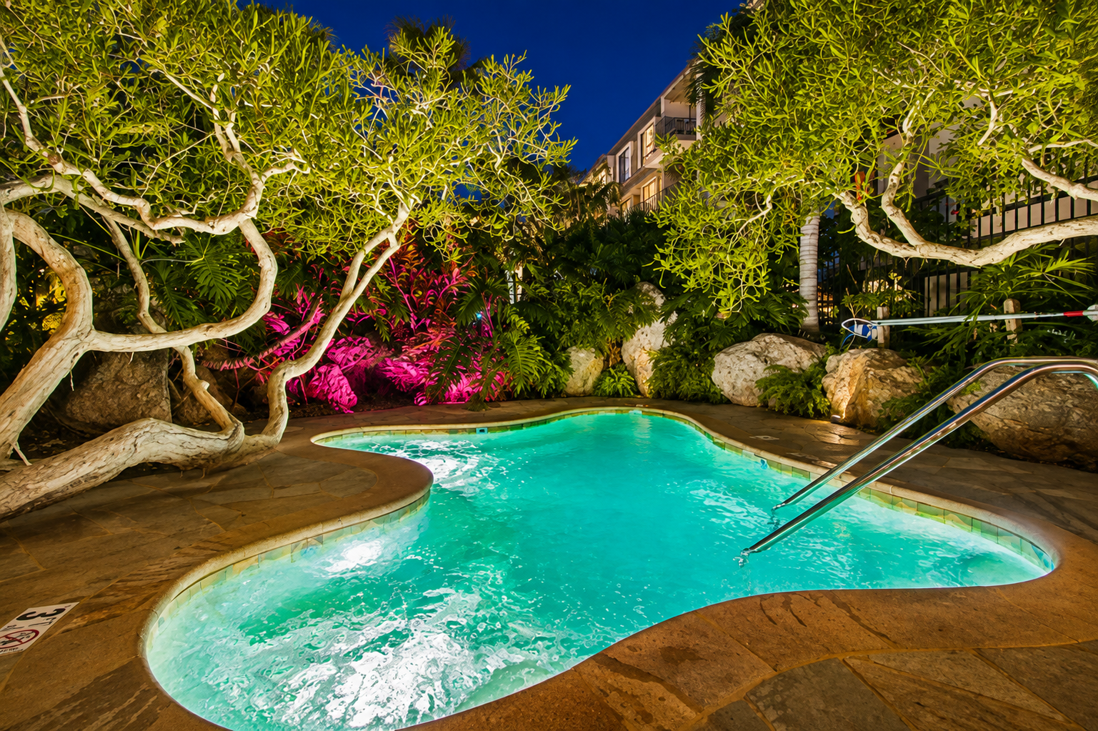 Secluded hot tub surrounded by tropical landscaping