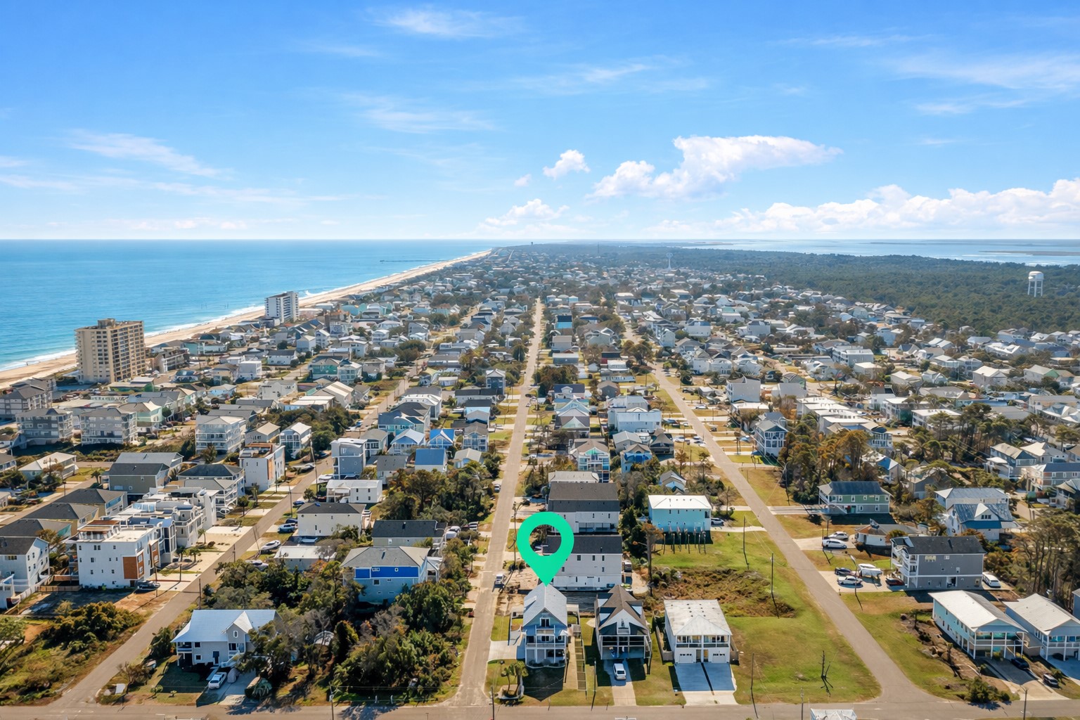 Wide aerial view of Carolina Beach — only 1 mile to the Boardwalk, home to restaurants, shops, and the seasonal carnival.