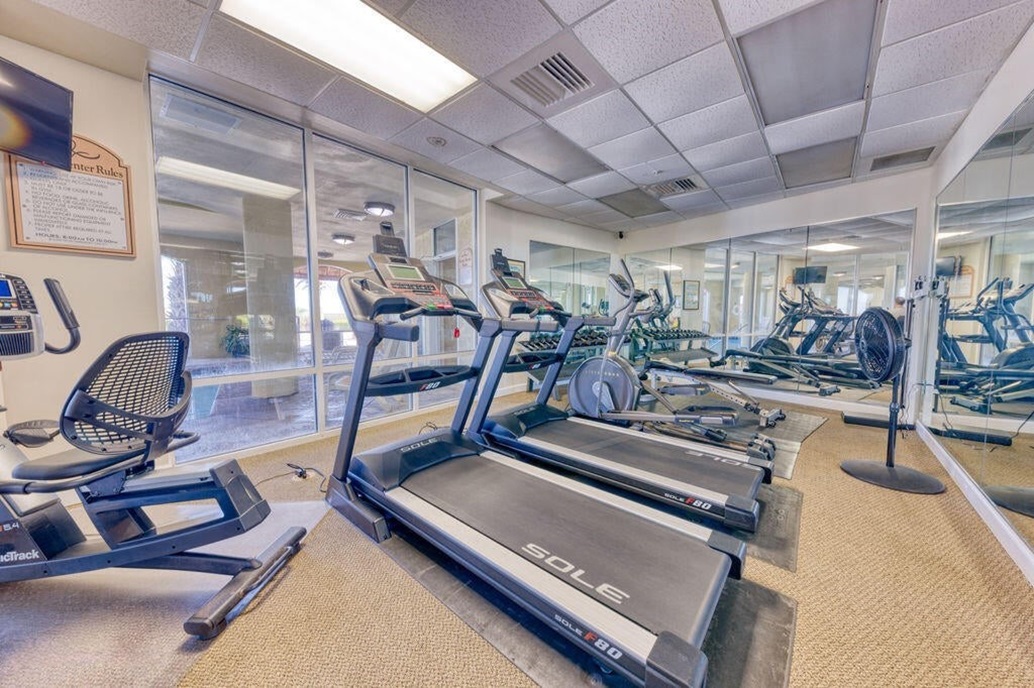 Fitness room looking into indoor pool.