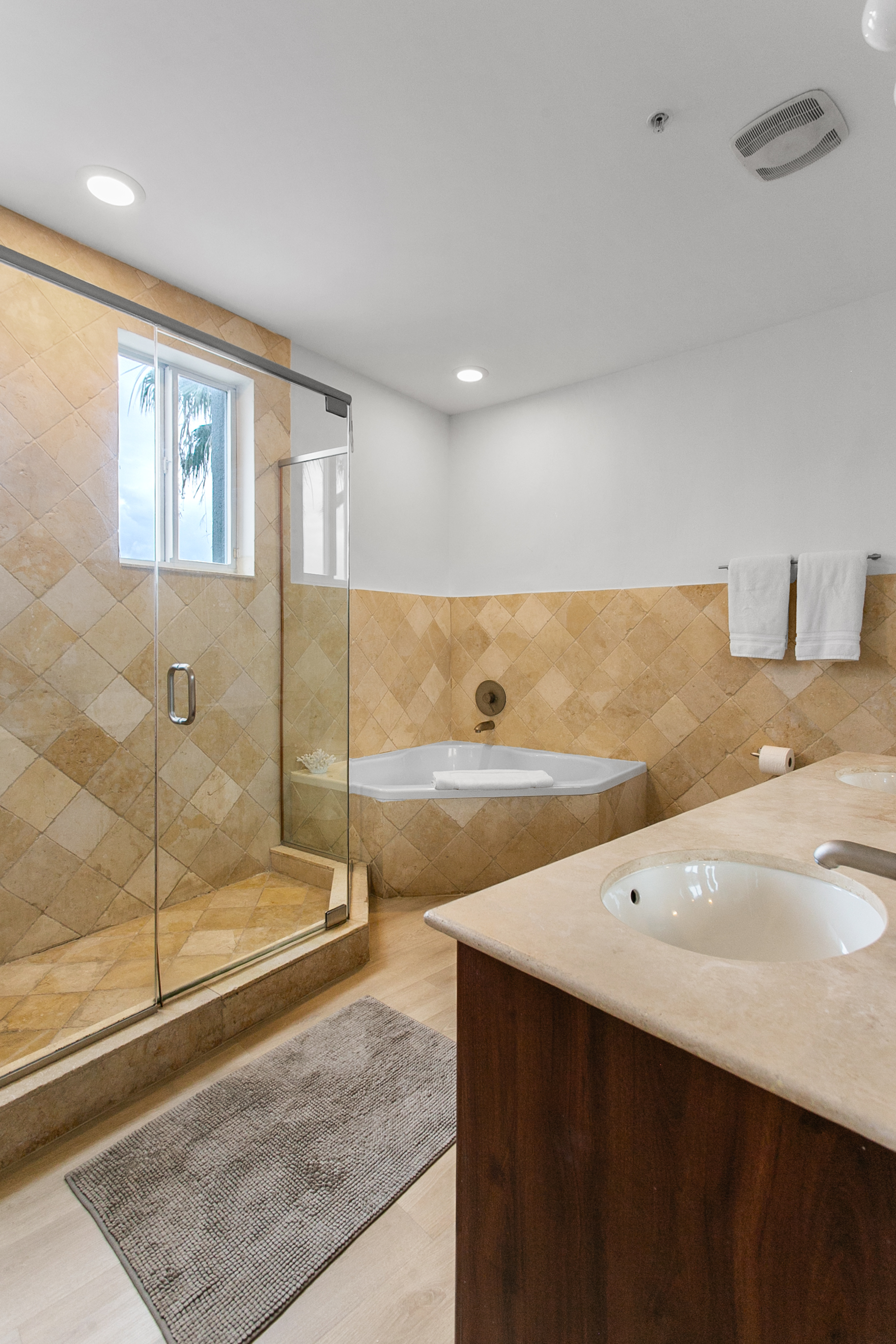 Primary Suite en-suite with separate tub and walk-in shower, double-sink vanity