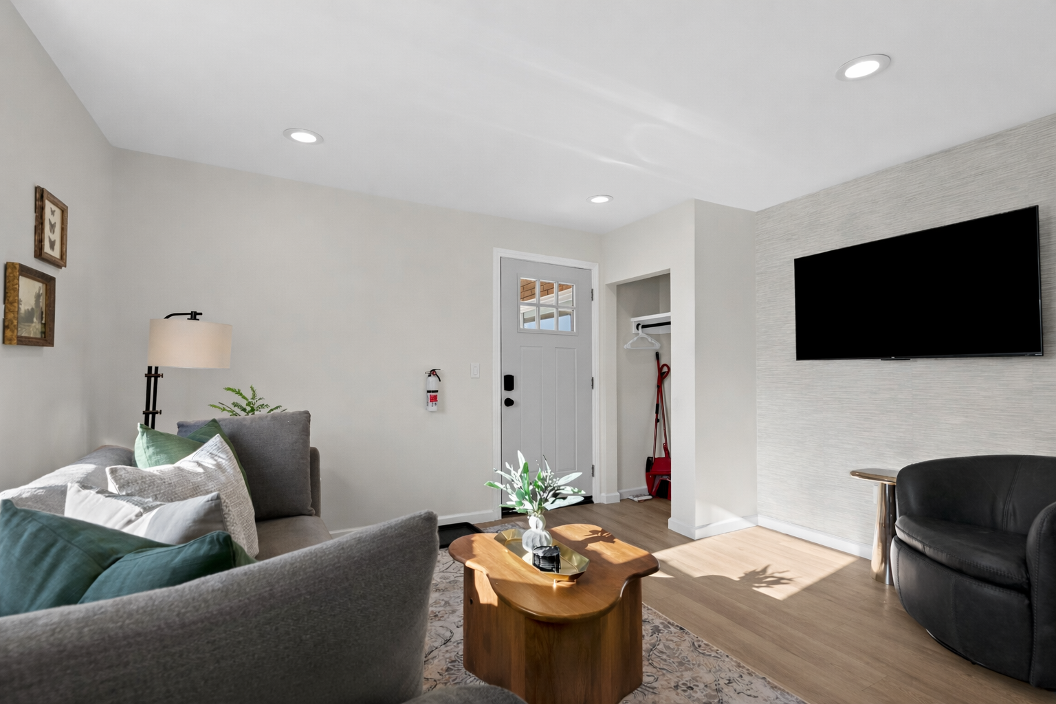 Spacious, sun-filled living room with modern furnishings, smart TV, and thoughtful details—creating a comfortable and inviting space to relax.