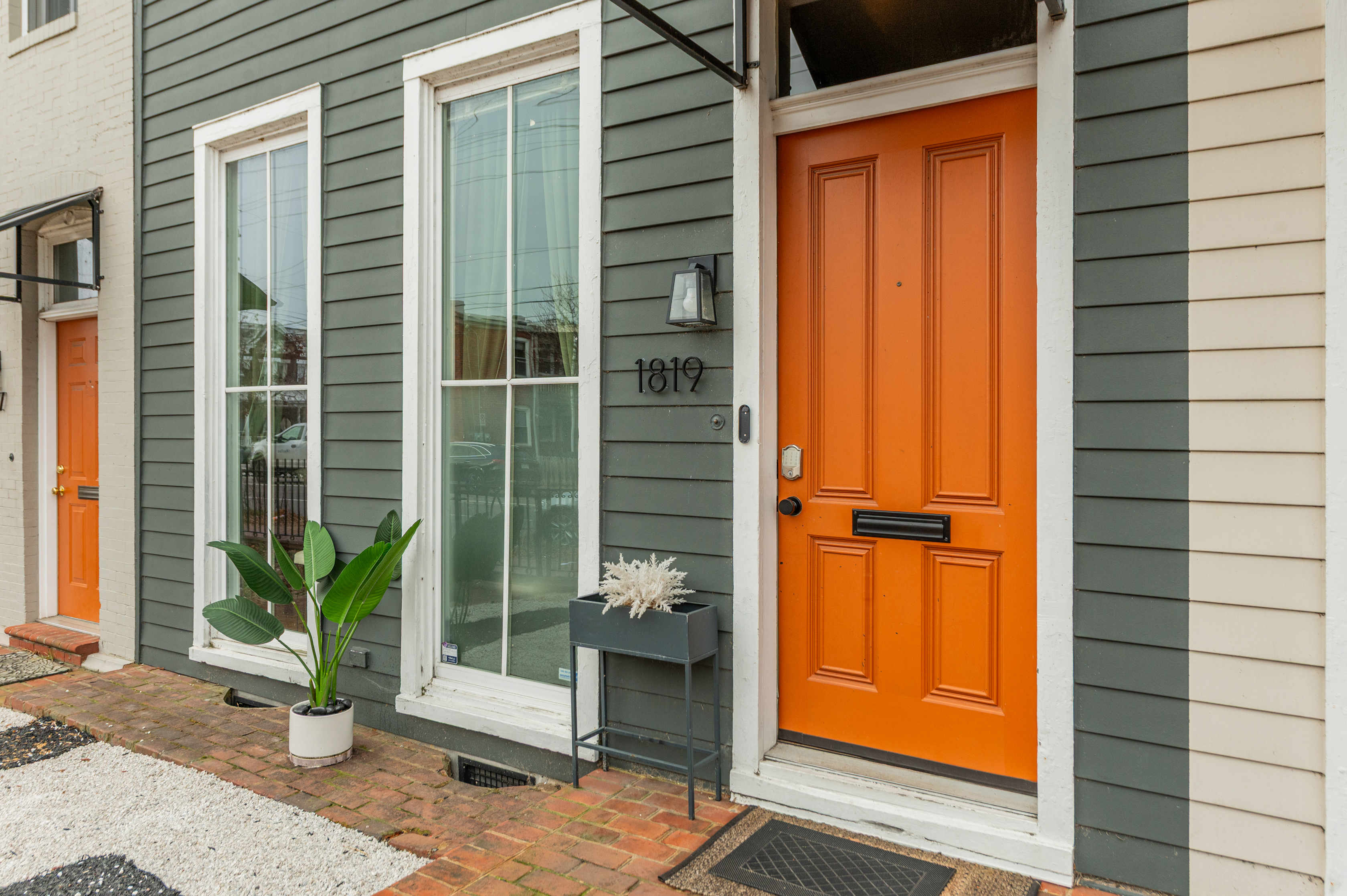 Charming Entrance: Bright orange door welcomes you to your Richmond adventure!
